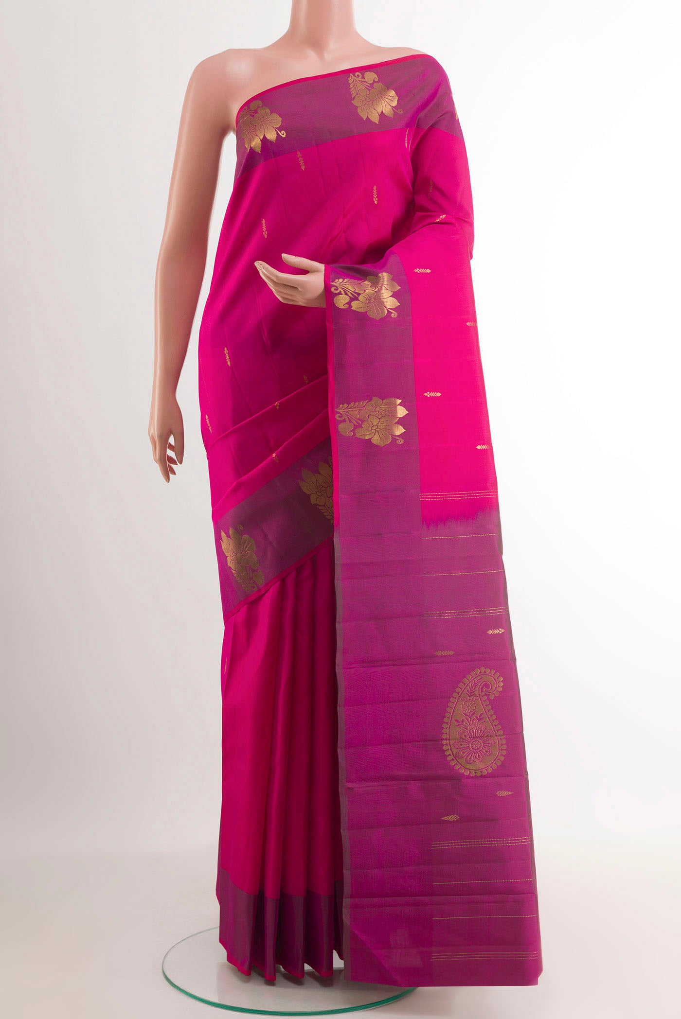 Rani Pink Kanchipuram Silk Saree with Zari Butta on the body and Zari Border.  displayed on a mannequin