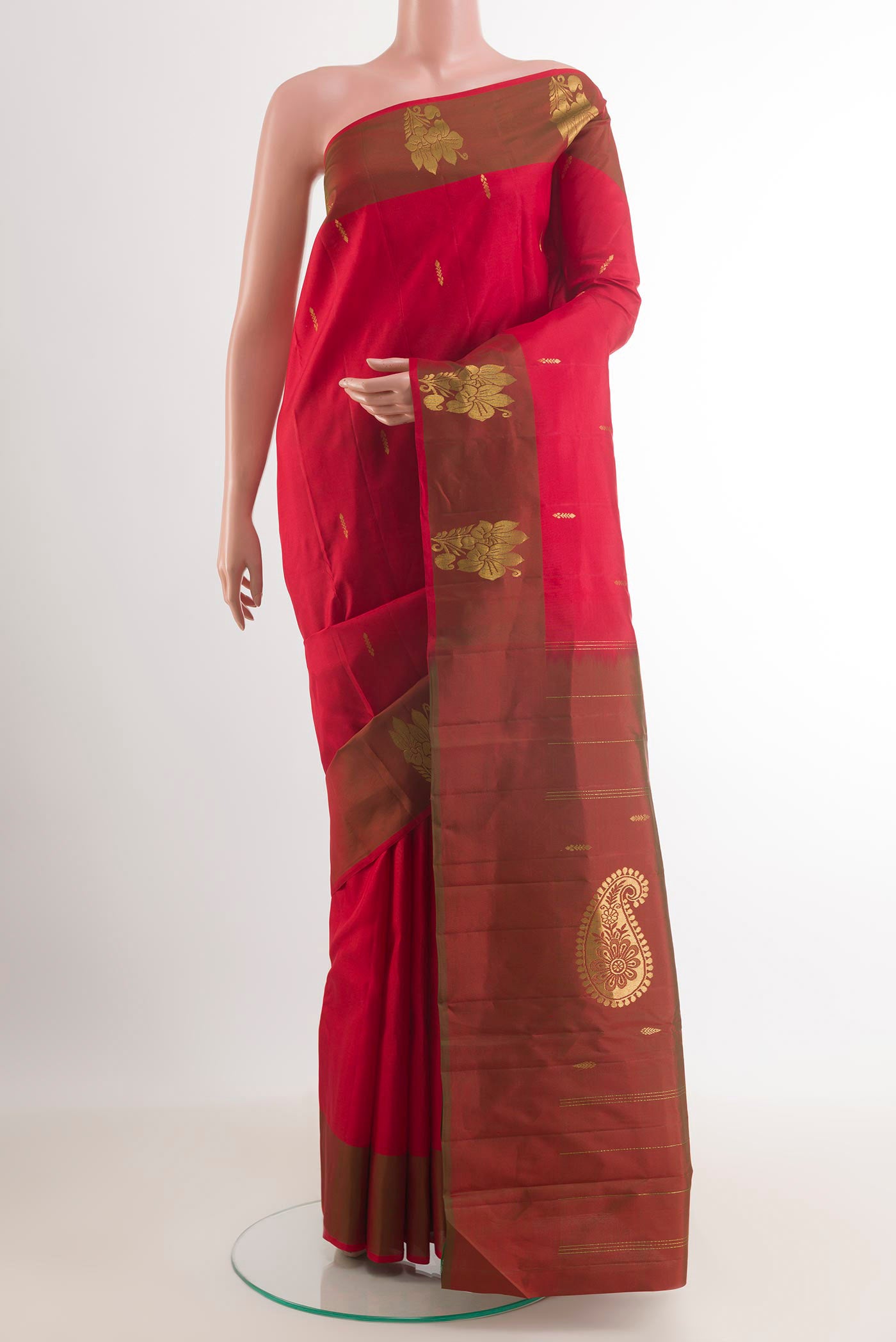 Red Kanchipuram Saree with Zari Butta on the body and Zari Border.  displayed on a mannequin