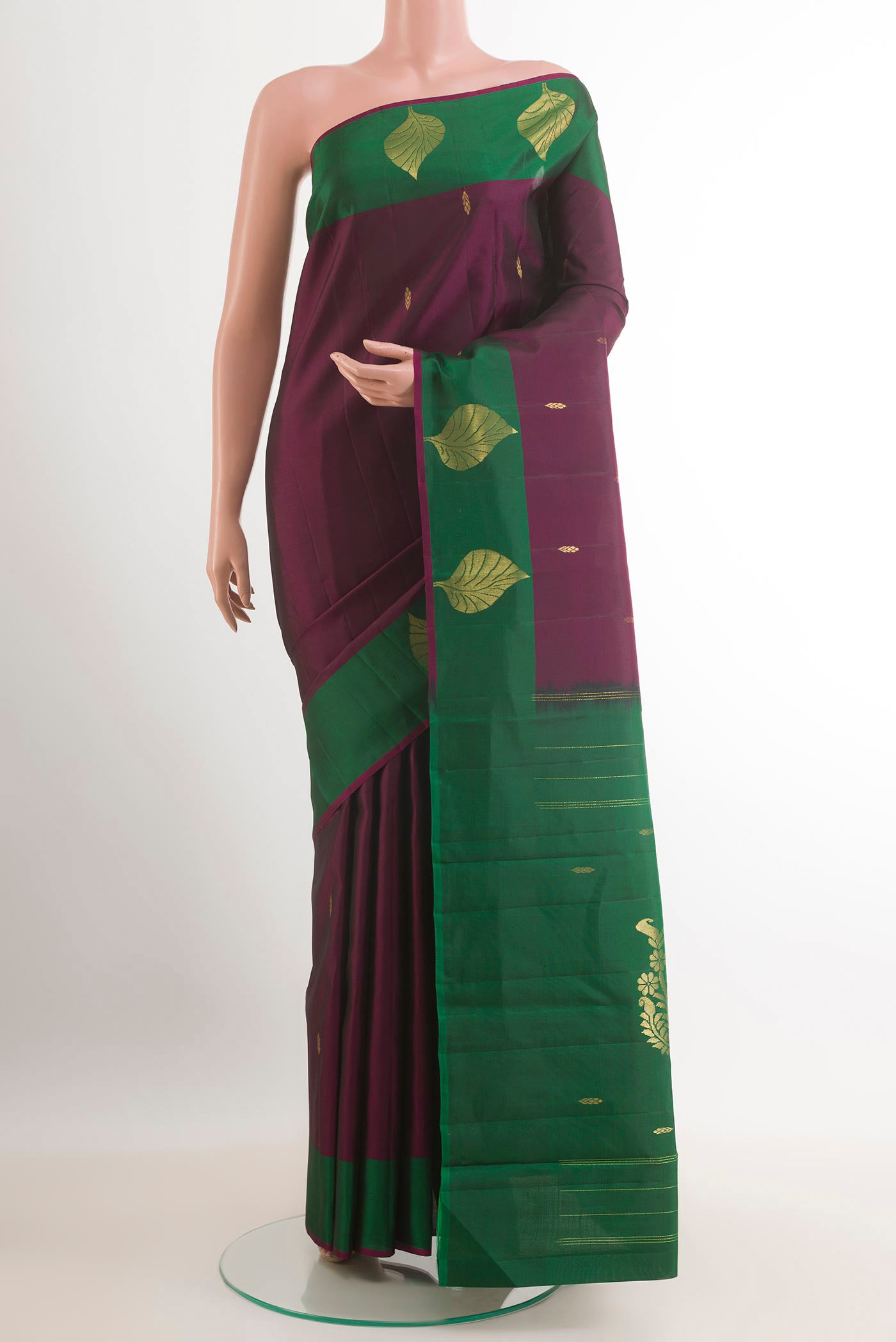 Purple Kanchipuram Silk Saree with Zari Butta on the body and Zari Border.  displayed on a mannequin