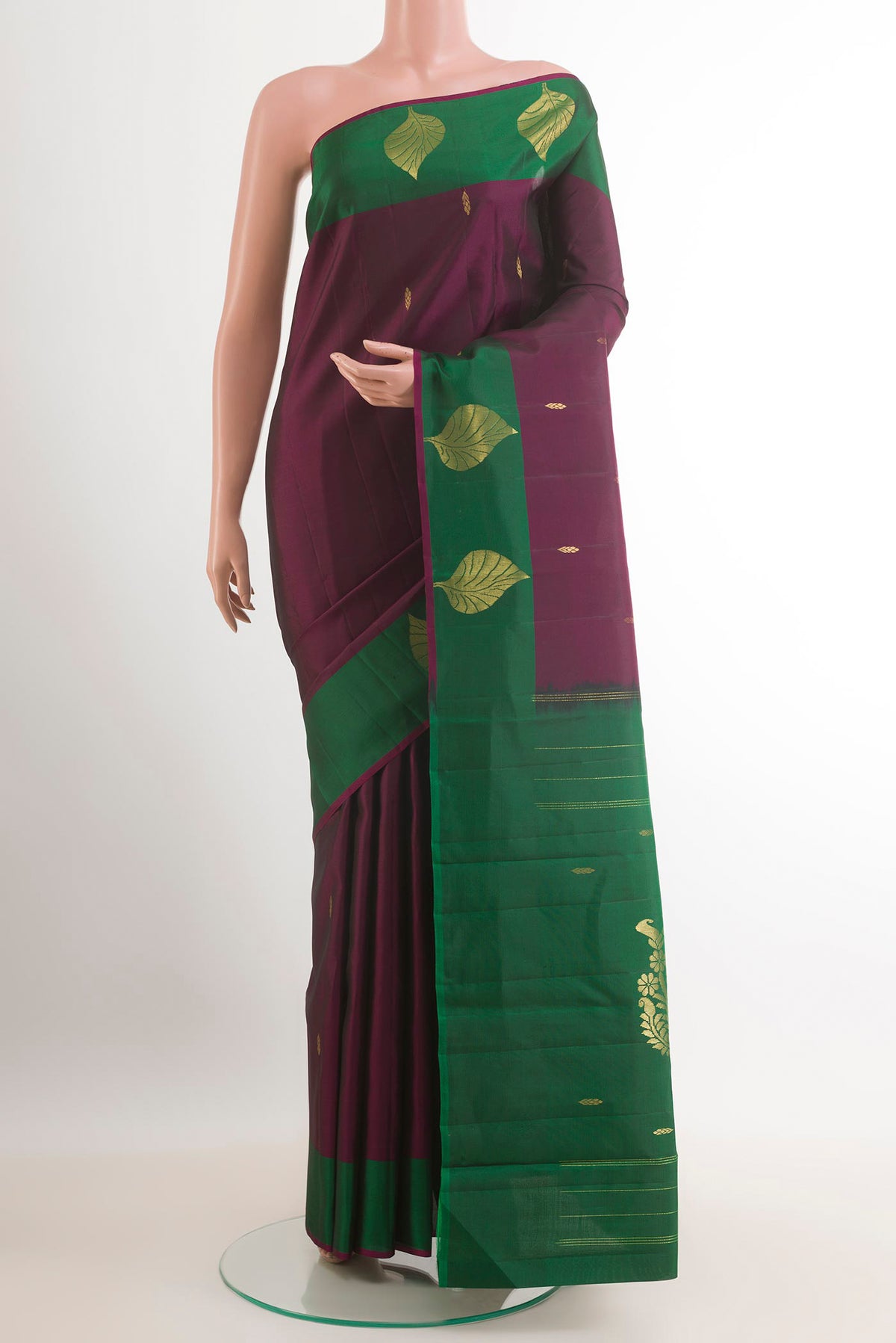 Purple Kanchipuram Silk Saree with Zari Butta on the body and Zari Border.  displayed on a mannequin