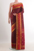 Brown Kanjivaram Silk Saree with Zari Butta on the body and Zari Border.  displayed on a mannequin