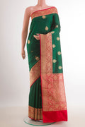 Green Banarasi Katan Silk Saree with Zari Butta on the body and Zari Border.  displayed on a mannequin