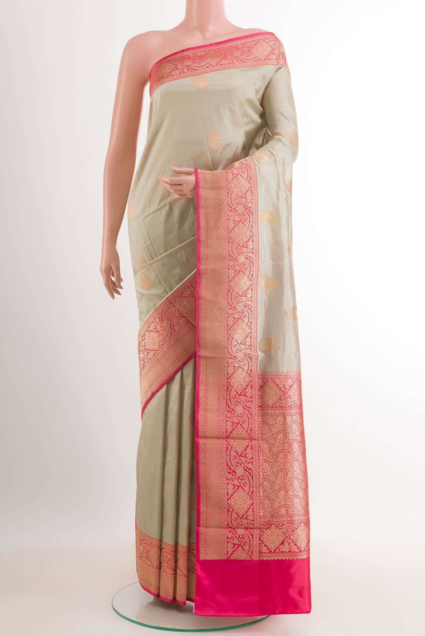 Grey Banarasi Katan Silk Saree with Zari Butta on the body and Zari Border.  displayed on a mannequin