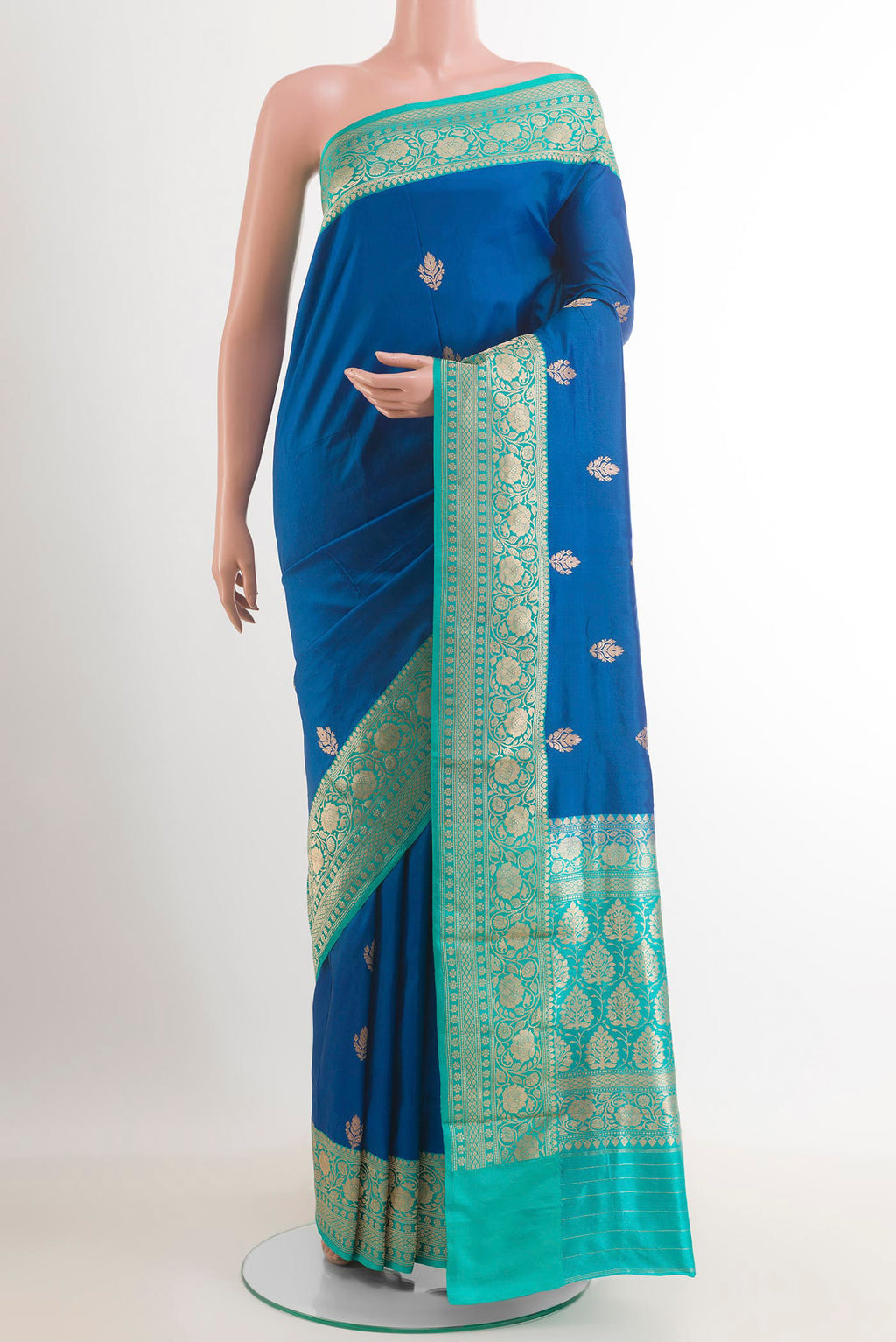 Blue Banarasi Katan Silk Saree with Zari Butta on the body and Zari Border.  displayed on a mannequin