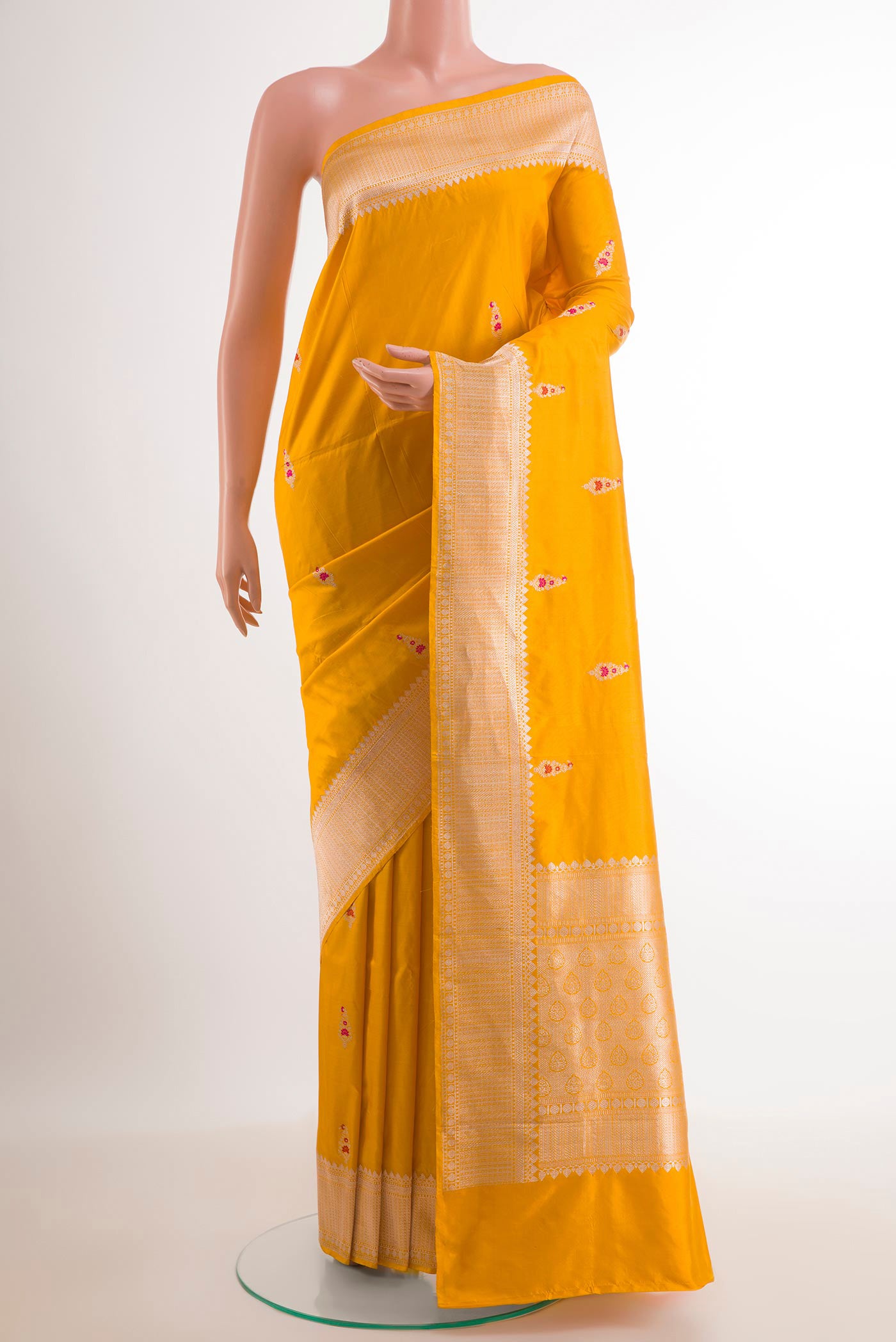 Yellow Banarasi Katan Silk Saree with Zari Butta on the body and Zari Border.  displayed on a mannequin