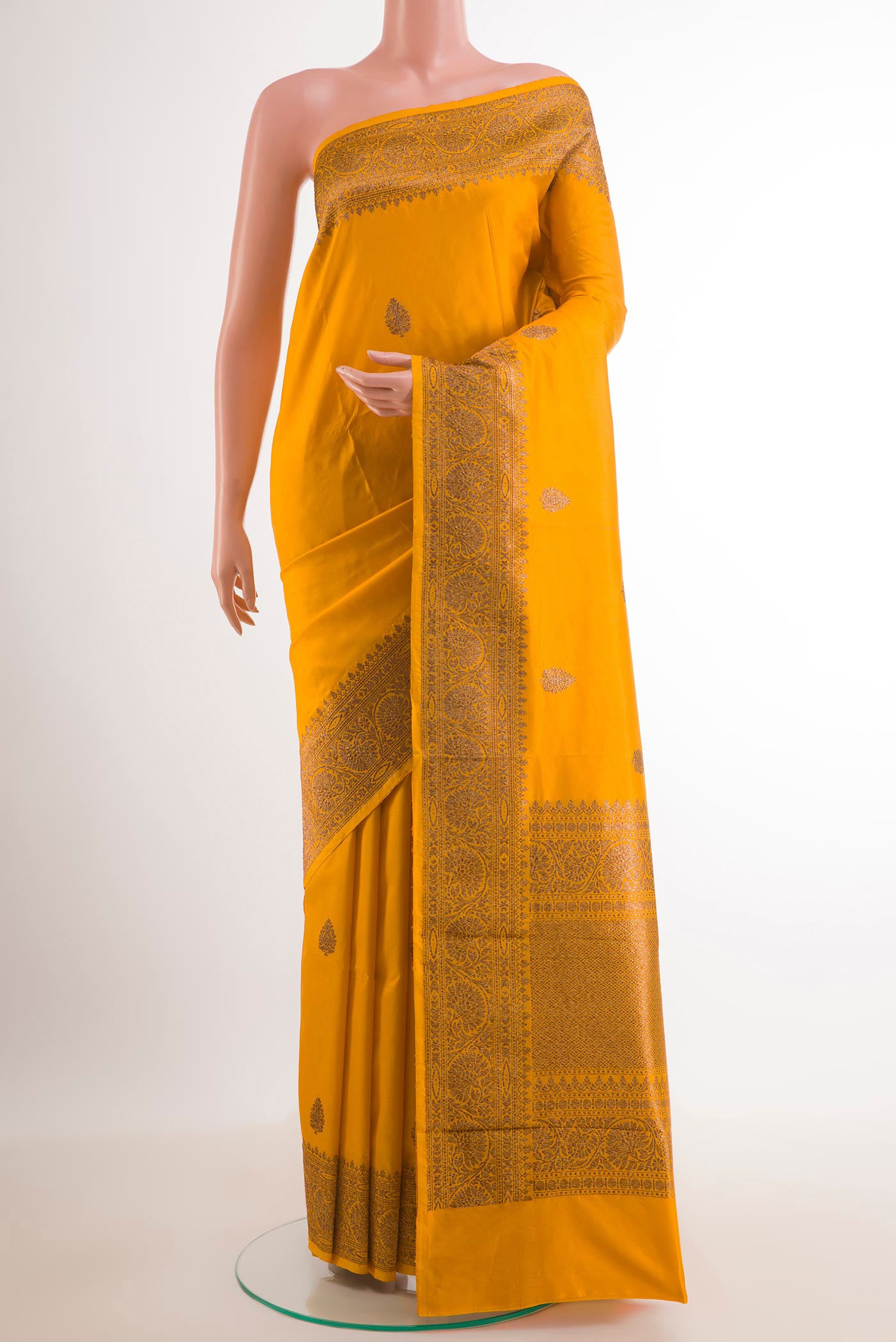 Yellow Banarasi Katan Silk Saree with Zari Butta on the body and Zari Border.  displayed on a mannequin