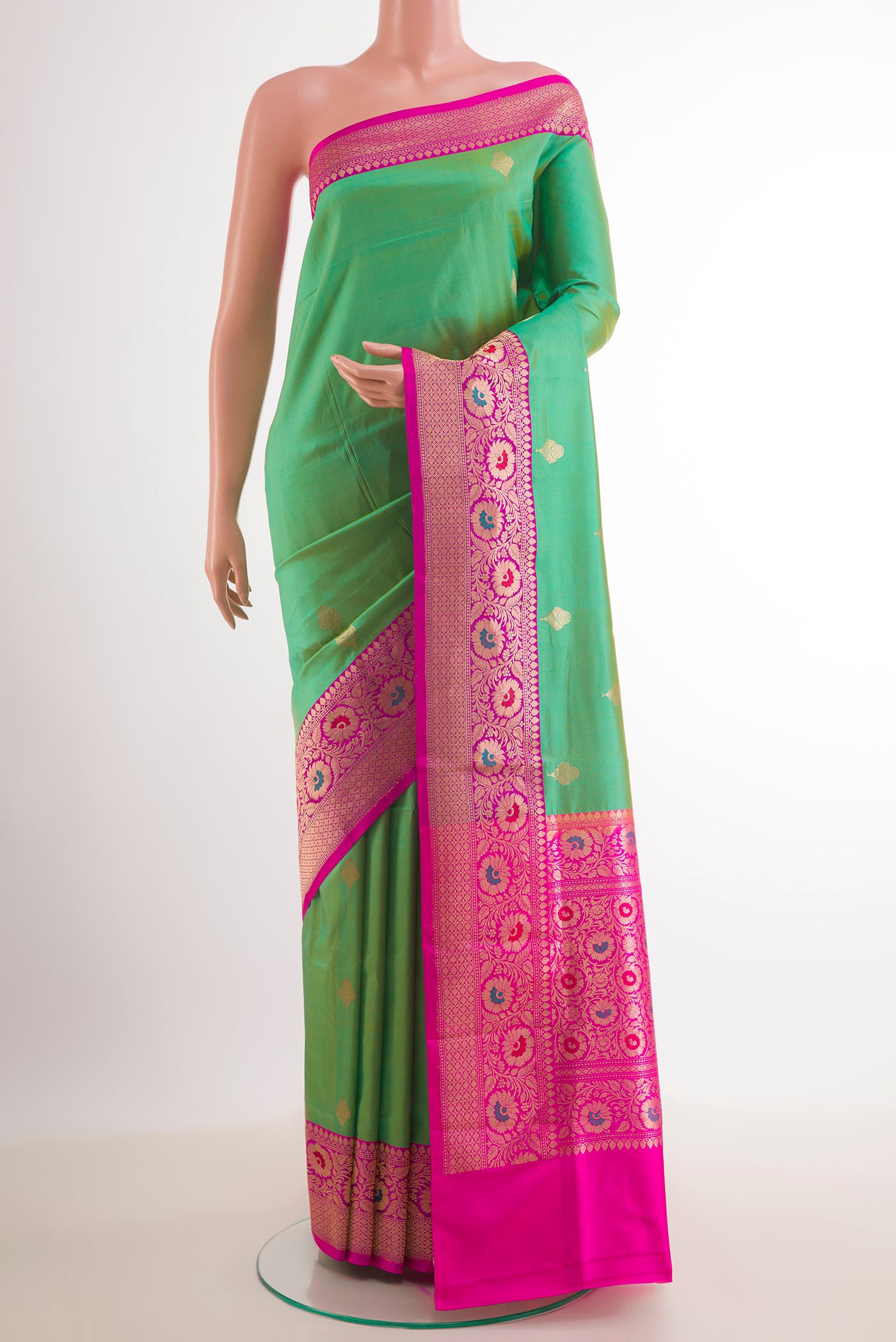 Green Banarasi Katan Silk Saree with Zari Butta on the body and Zari Border.  displayed on a mannequin