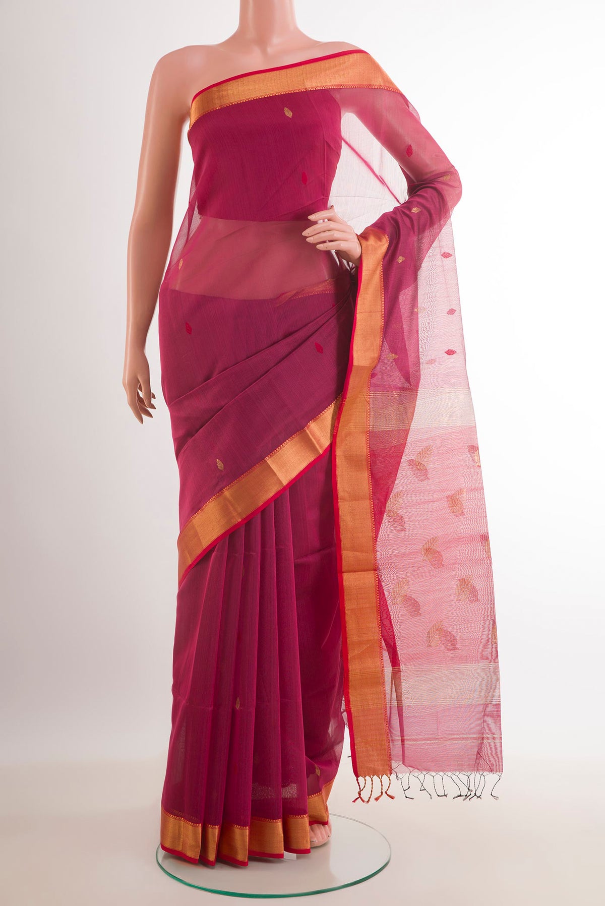 Magenta Blended Kora Cotton Saree with Zari Butta on the body and Zari Border.  displayed on a mannequin
