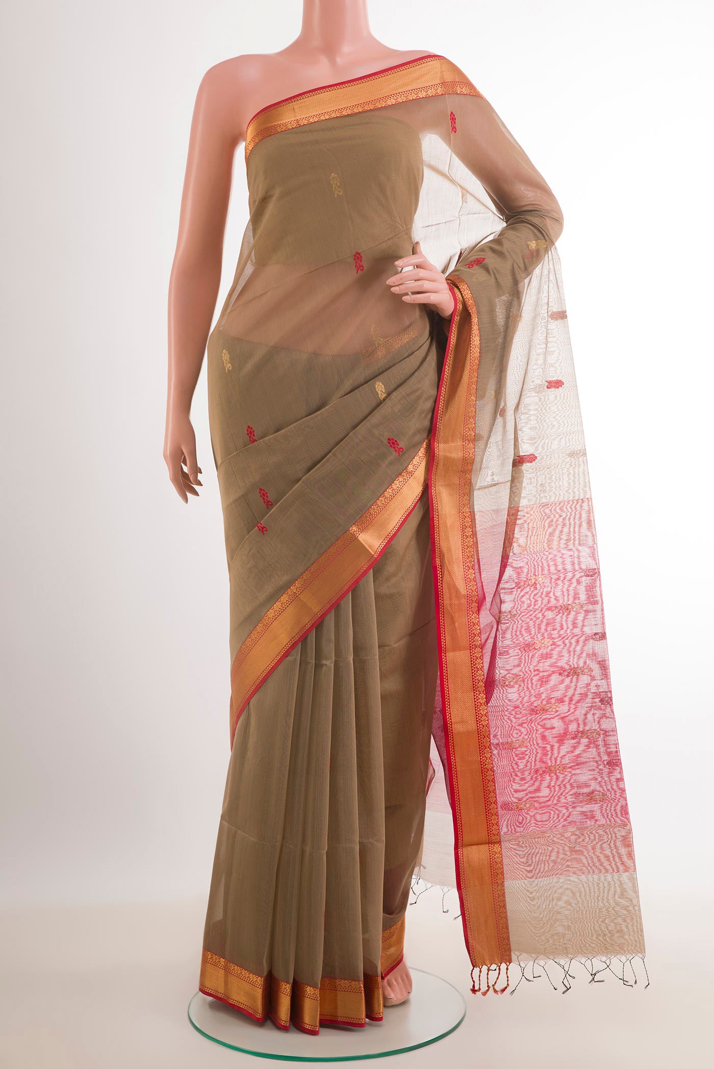 Beige Blended Kora Cotton Saree with Zari And Thread Butta on the body and Zari Border.  displayed on a mannequin