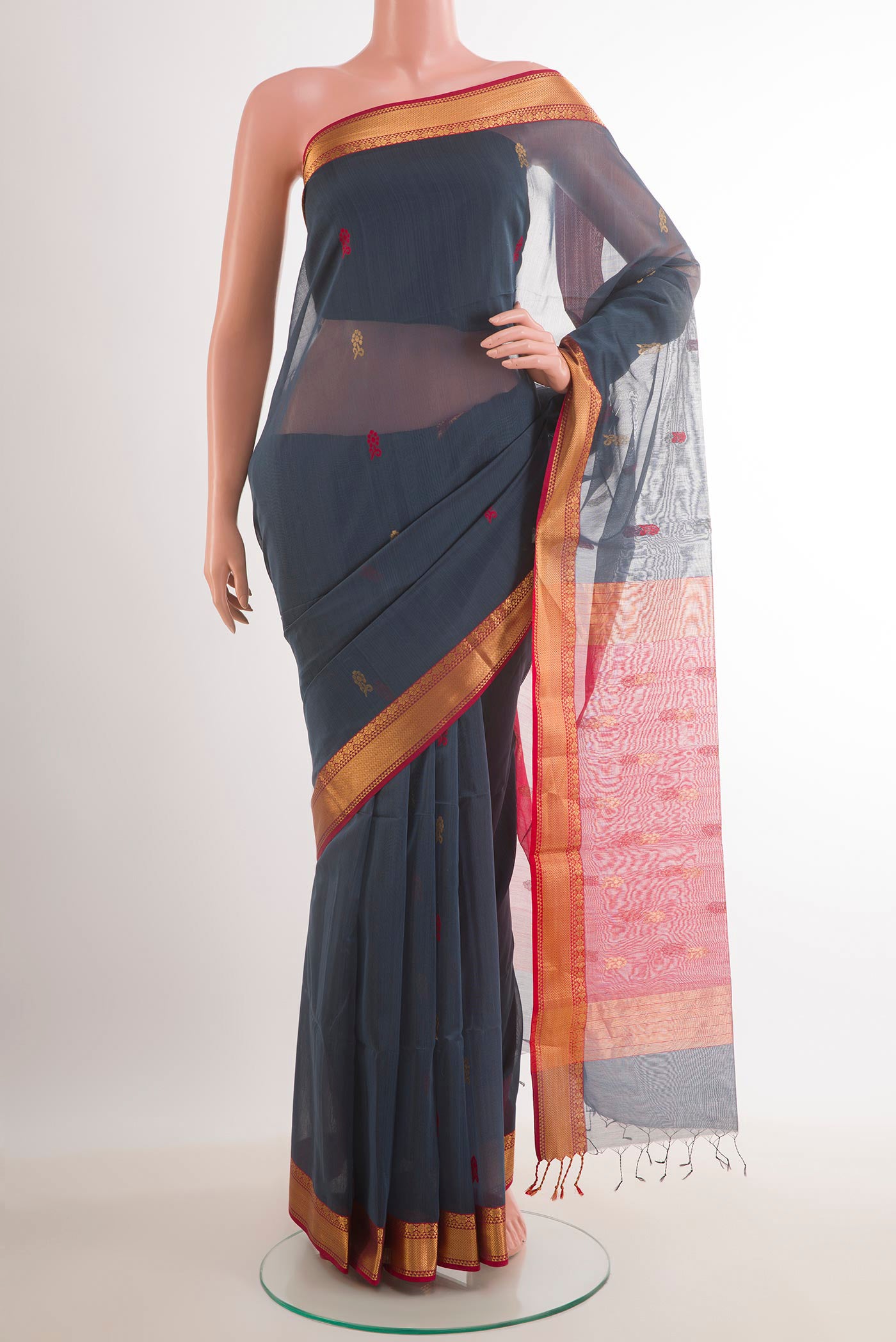 Grey Blended Kora Cotton Saree with Zari And Thread Butta on the body and Zari Border.  displayed on a mannequin