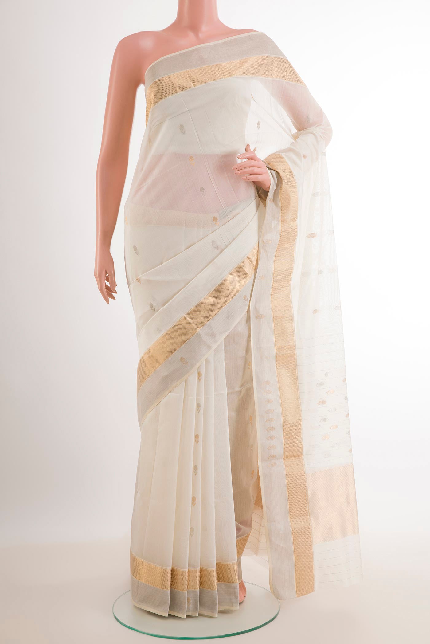 White Blended Kora Cotton Saree with Zari Butta on the body and Zari Border.  displayed on a mannequin