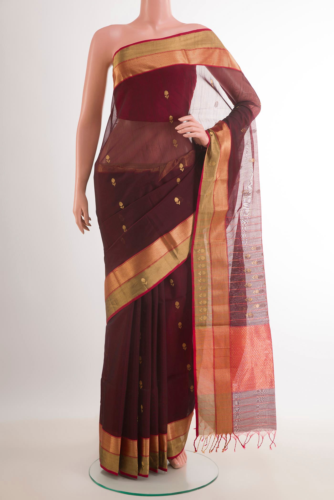 Maroon Blended Kora Cotton Saree with Zari Butta on the body and Zari Border.  displayed on a mannequin
