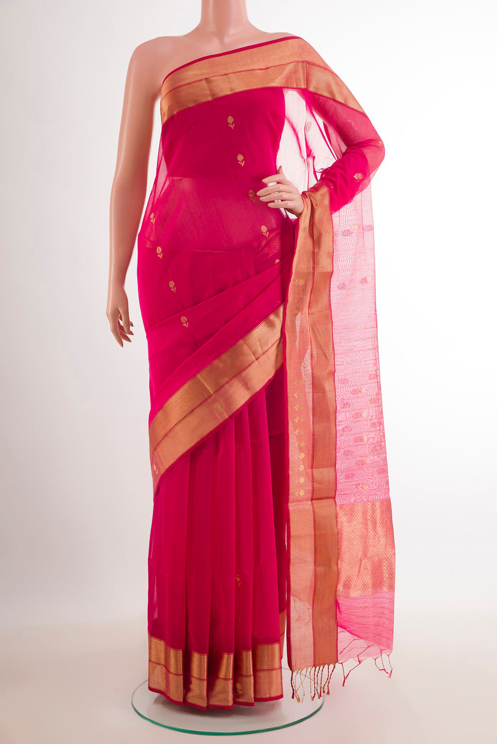 Rani Pink Blended Kora Cotton Saree with Zari Butta on the body and Zari Border.  displayed on a mannequin