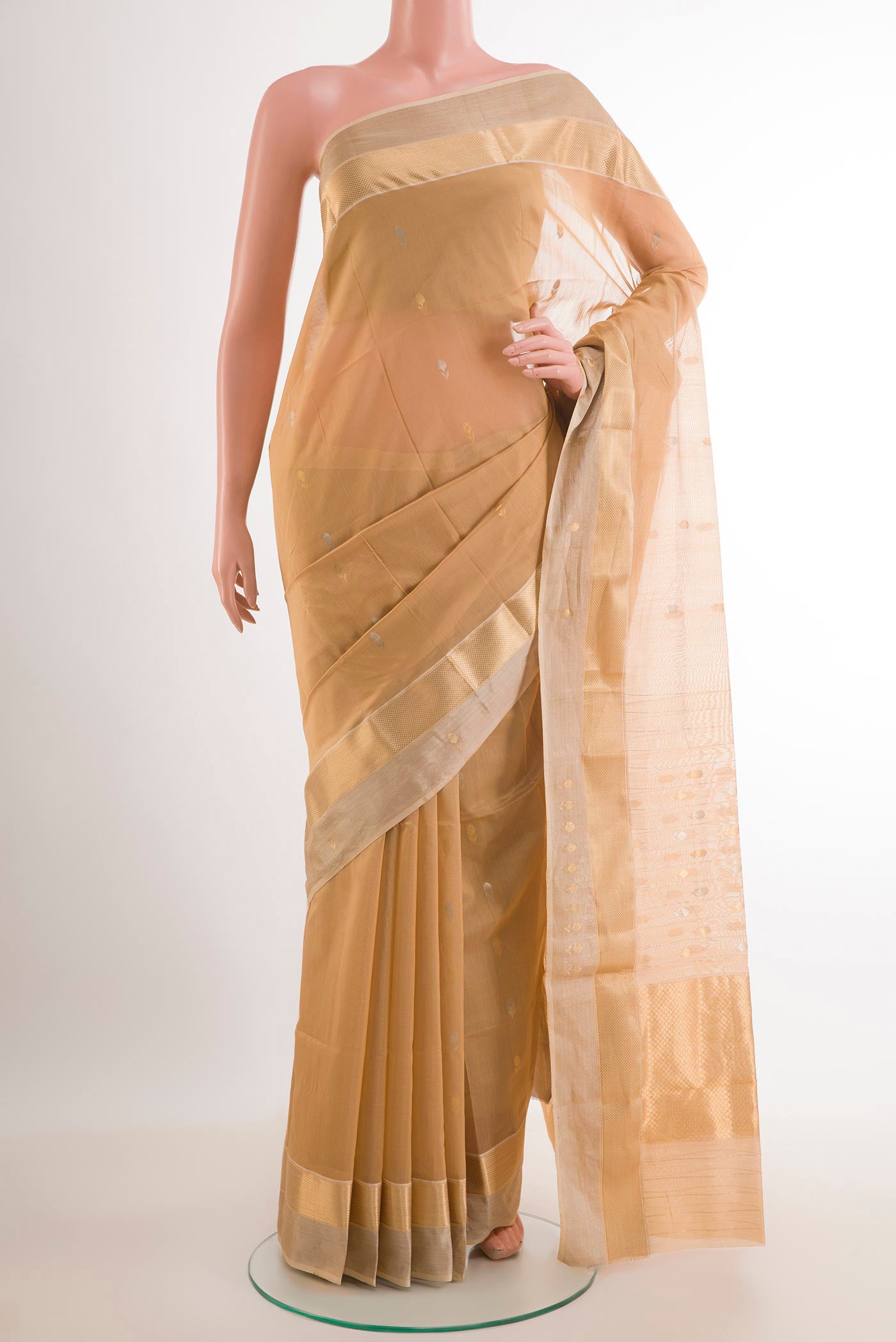 Beige Blended Kora Cotton Saree with Zari And Thread Butta on the body and Zari Border.  displayed on a mannequin