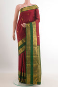 Maroon Kanchipuram Silk Saree with Zari Butta on the body and Zari Border.  displayed on a mannequin