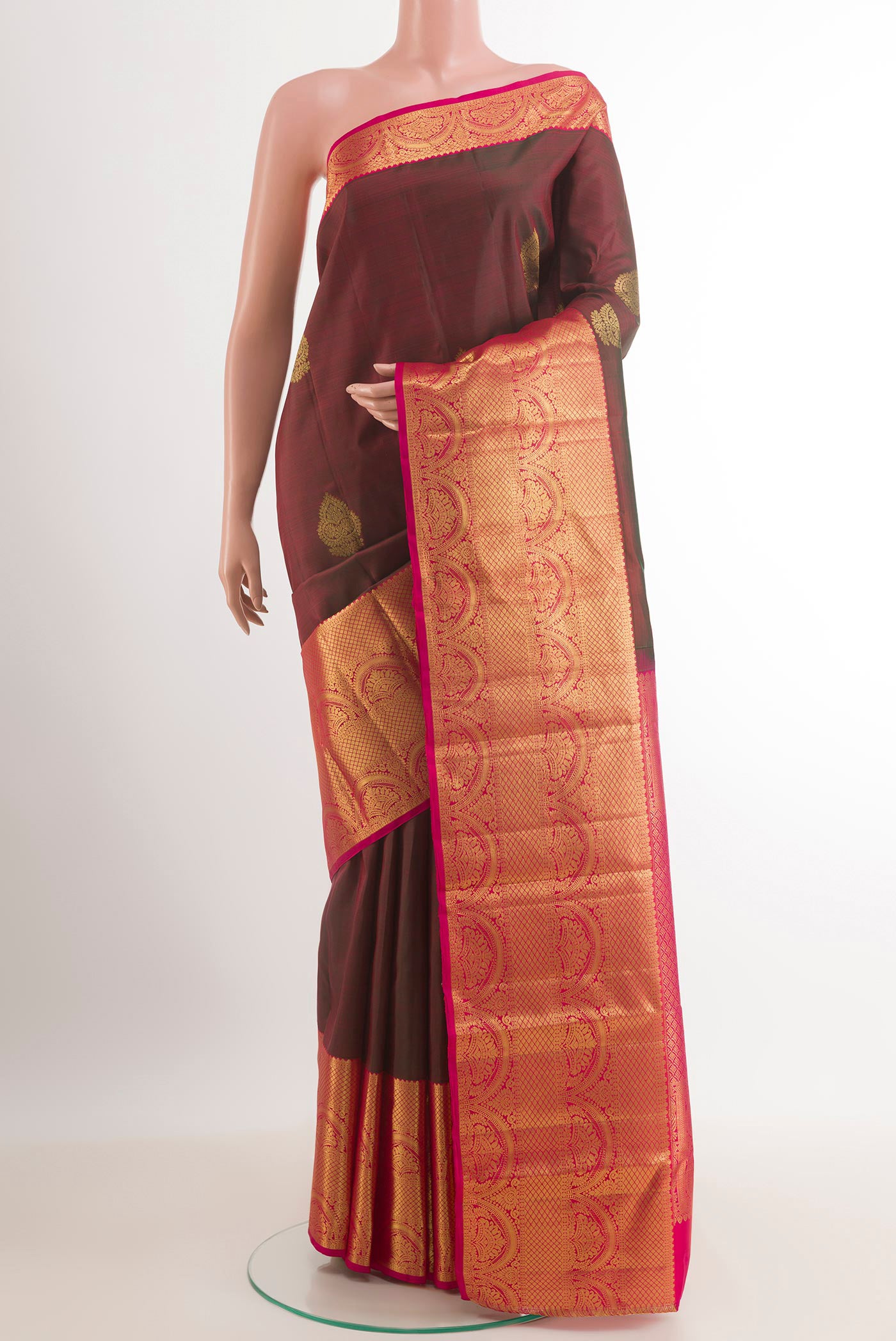 Maroon Kanchipuram Silk Saree with Zari Butta on the body and Zari Border.  displayed on a mannequin