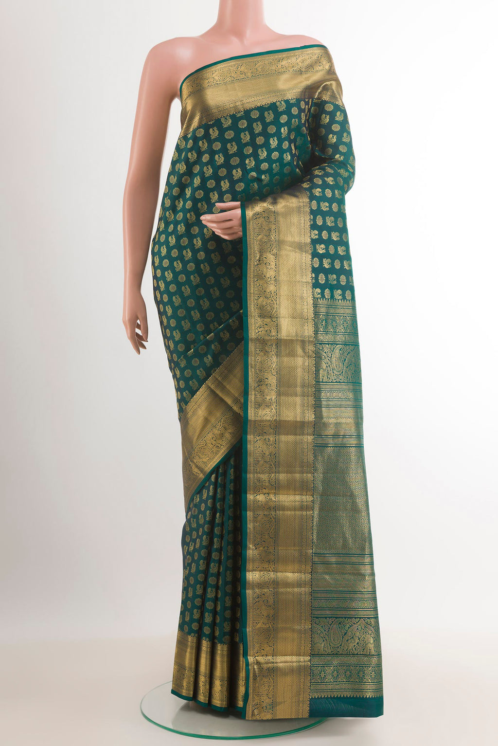 Bottle Green Kanjivaram Silk Saree with Zari Butta on the body and Zari Border.  displayed on a mannequin