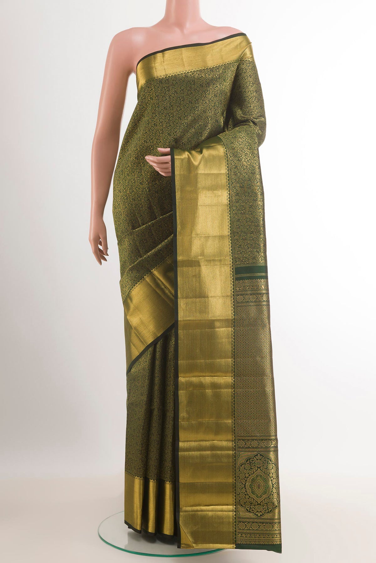 Bottle Green Kanjivaram Silk Saree with Zari Brocade on the body and Zari Border.  displayed on a mannequin