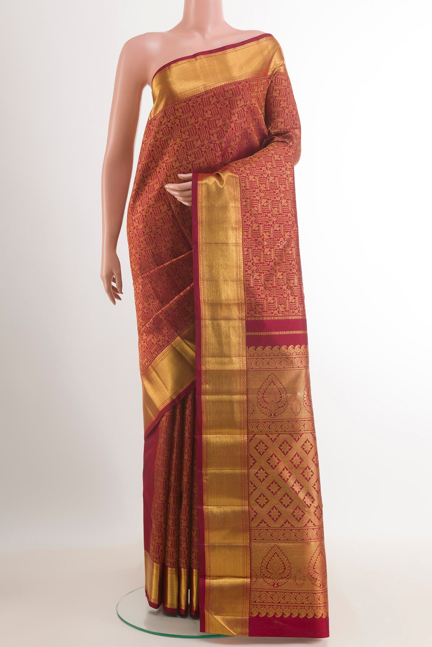 Maroon Kanchipuram Silk Saree with Zari Brocade on the body and Zari Border.  displayed on a mannequin