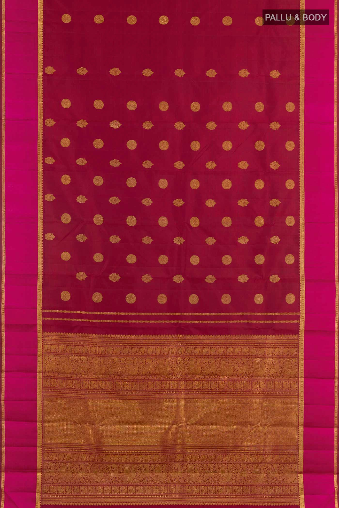 Flat view of Maroon Kanjivaram Silk Saree with Zari Butta on the body and Zari Border. 