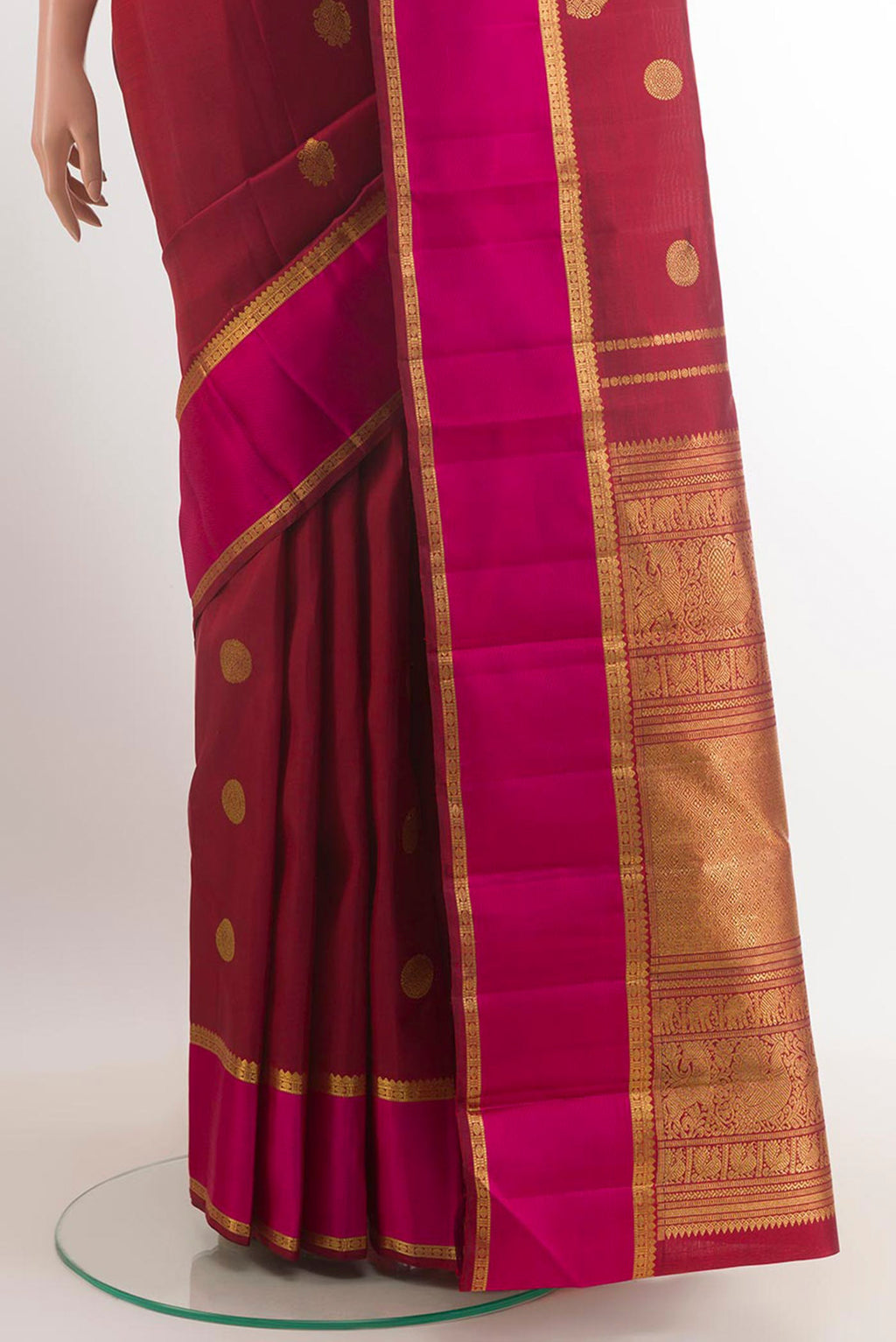 Pleats and pallu of Maroon Kanjivaram Silk Saree with Zari Butta on the body and Zari Border. 