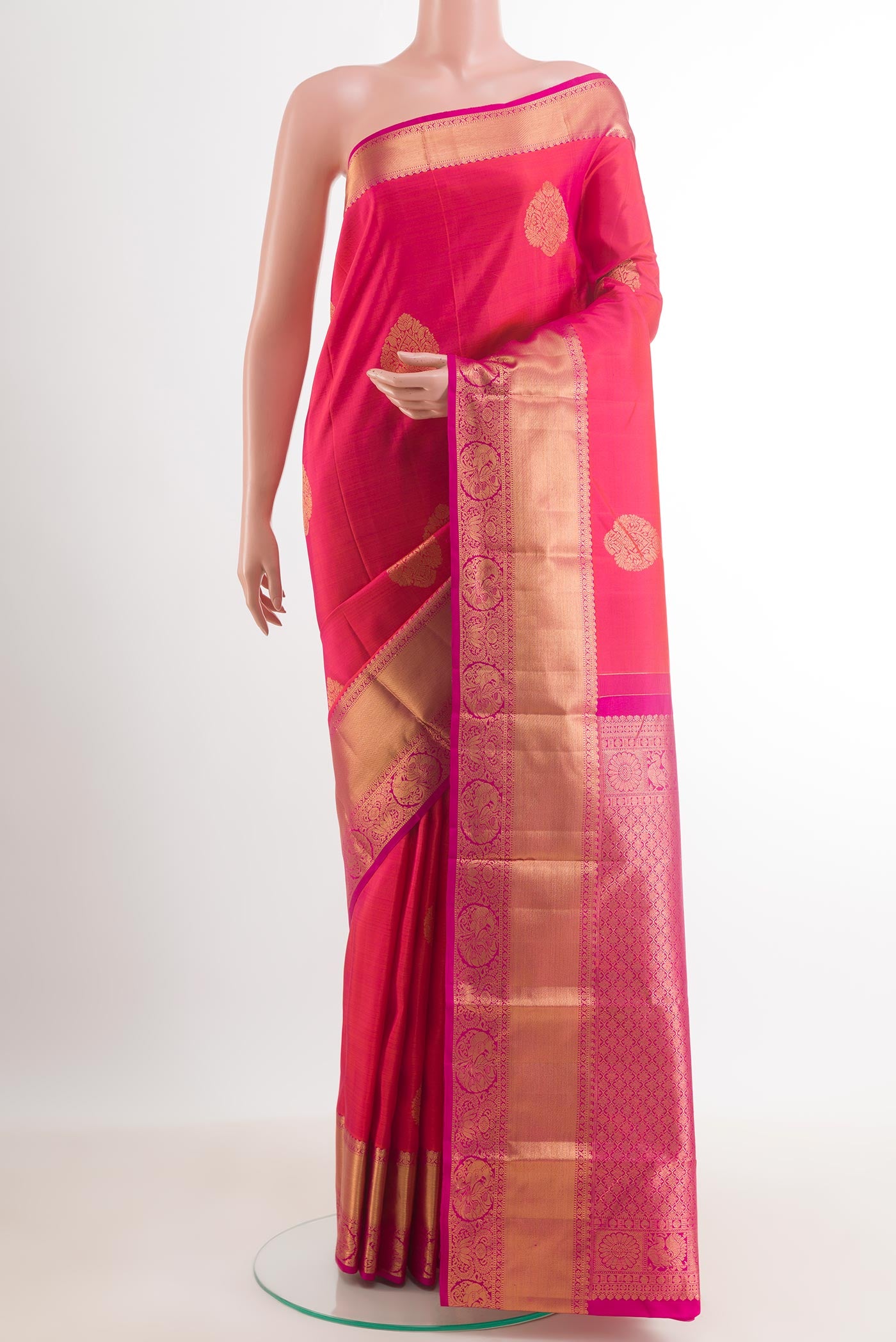 Peach Dual Tone Kanchipuram Silk Saree with Zari Butta on the body and Zari Border.  displayed on a mannequin