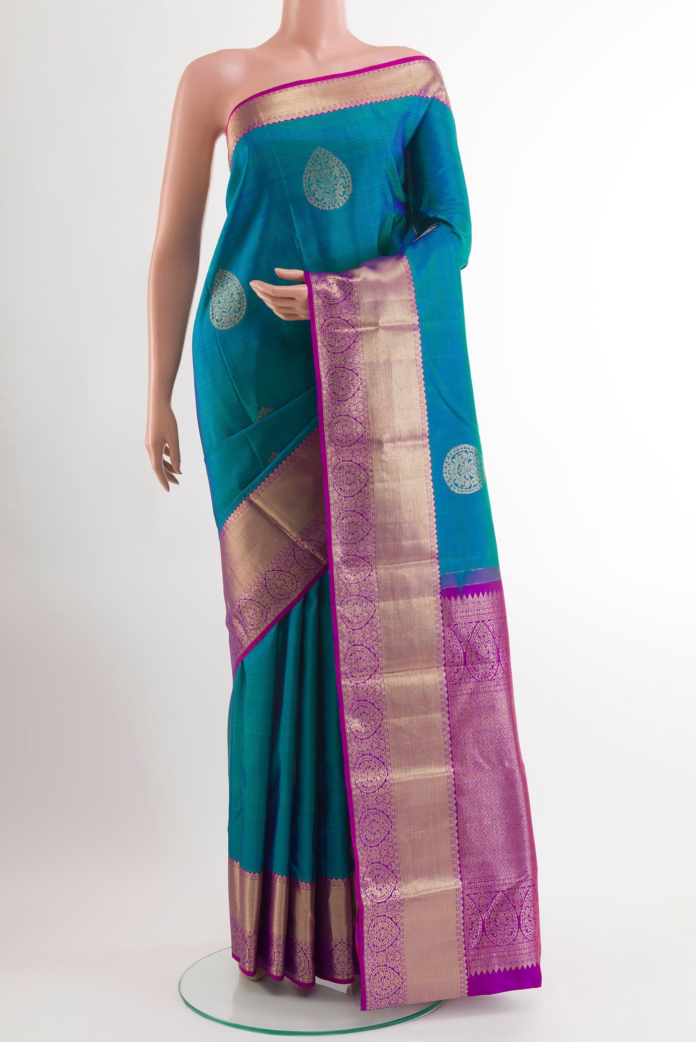 Peacock Blue Kanchipuram Silk Saree with Zari Butta on the body and Zari Border.  displayed on a mannequin