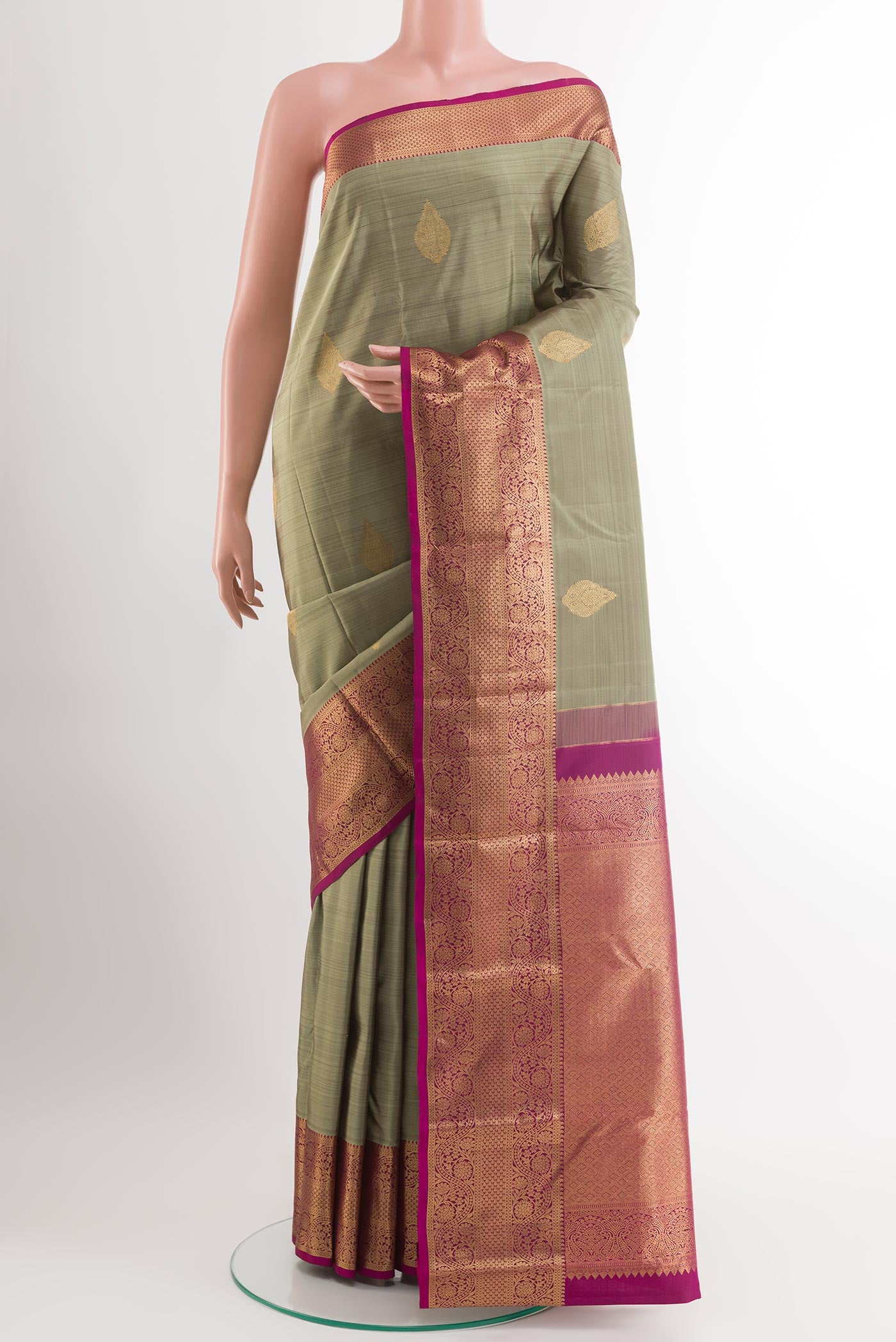 Sage Green Kanchipuram Silk Saree with Zari Butta on the body and Zari Border.  displayed on a mannequin