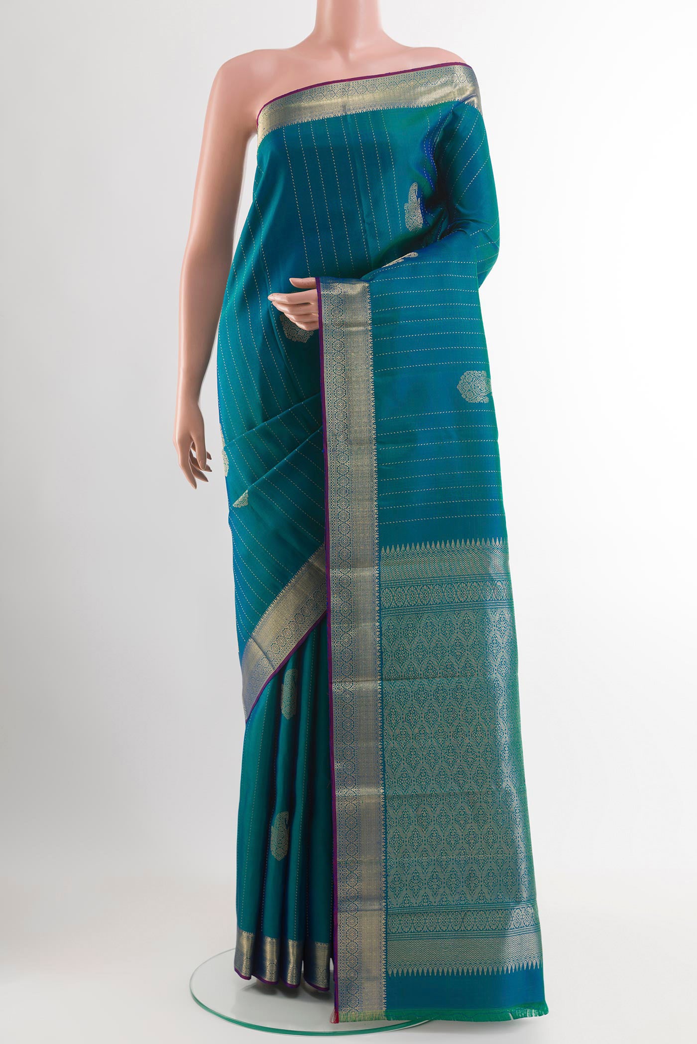 Peacock Blue Dual Tone Kanchipuram Silk Saree with Zari Butta on the body and Zari Border.  displayed on a mannequin