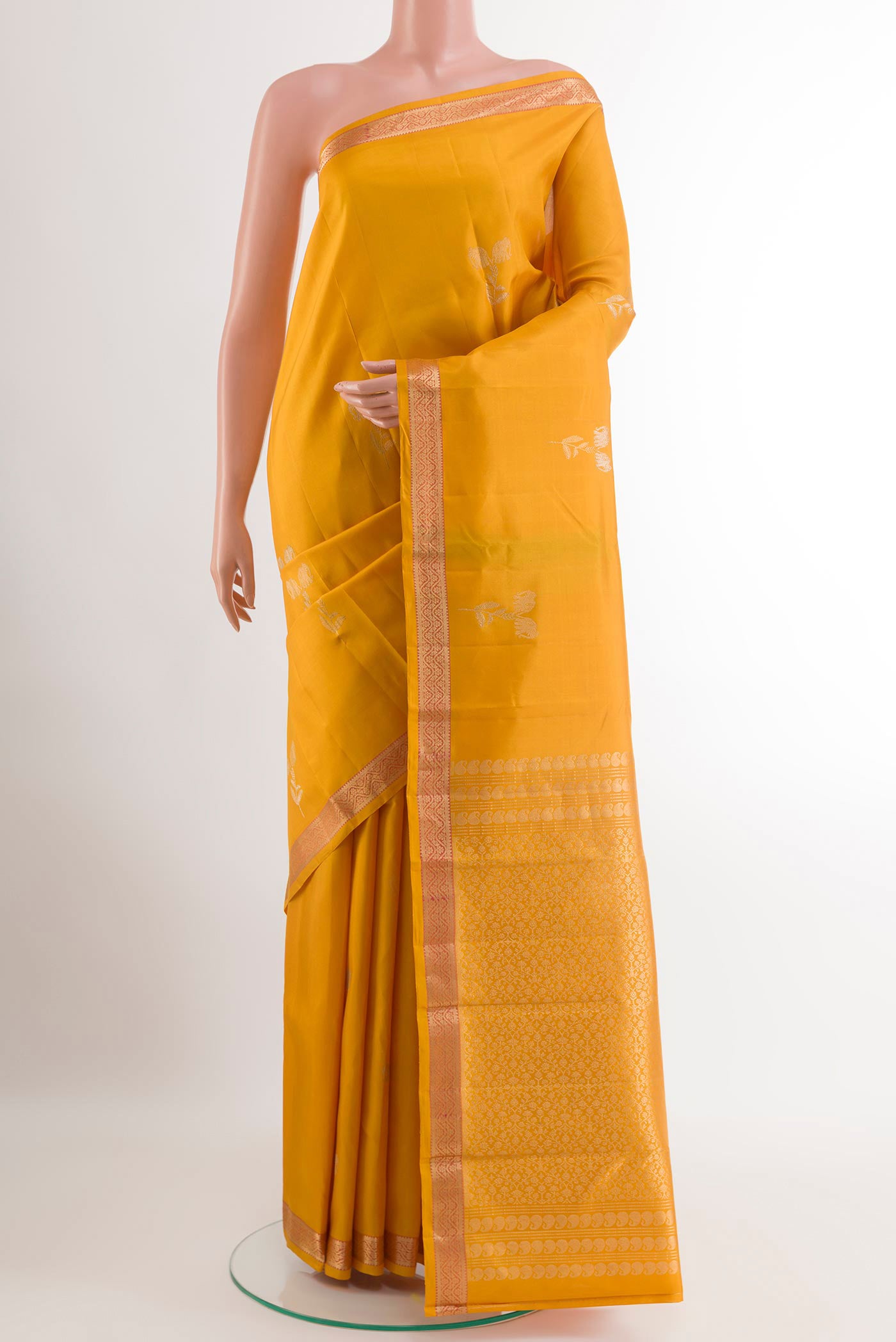 Yellow Kanchipuram Silk Saree with Zari Butta on the body and Zari Border.  displayed on a mannequin