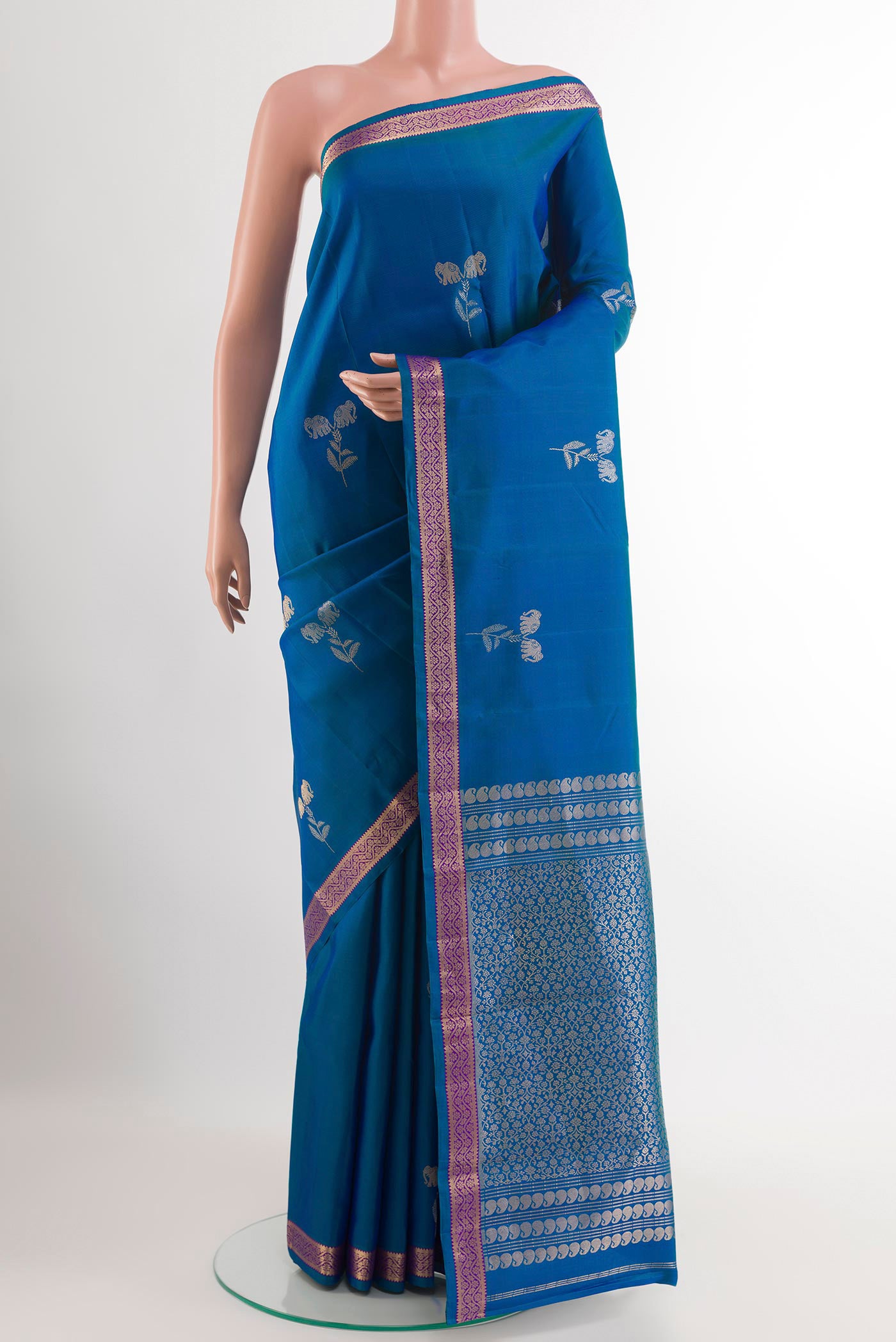Blue Kanchipuram Silk Saree with Zari Butta on the body and Zari Border.  displayed on a mannequin