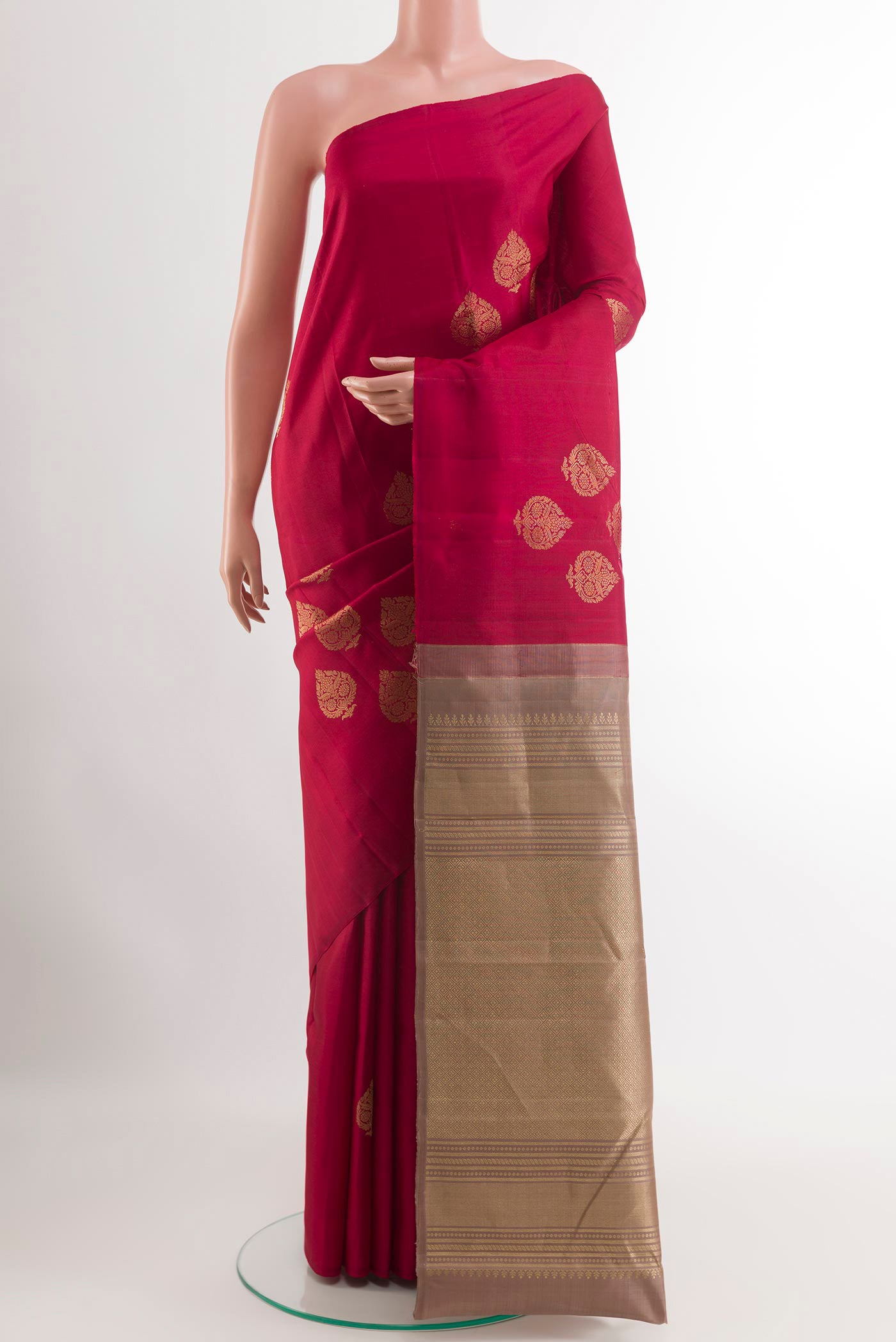 Maroon Kanchipuram Silk Saree with Zari Butta on the body and Zari Border.  displayed on a mannequin