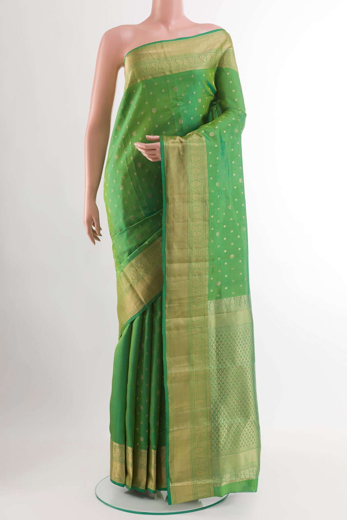 Green Dual Tone Kanjivaram Silk Saree with Zari Butta on the body and Zari Border.  displayed on a mannequin