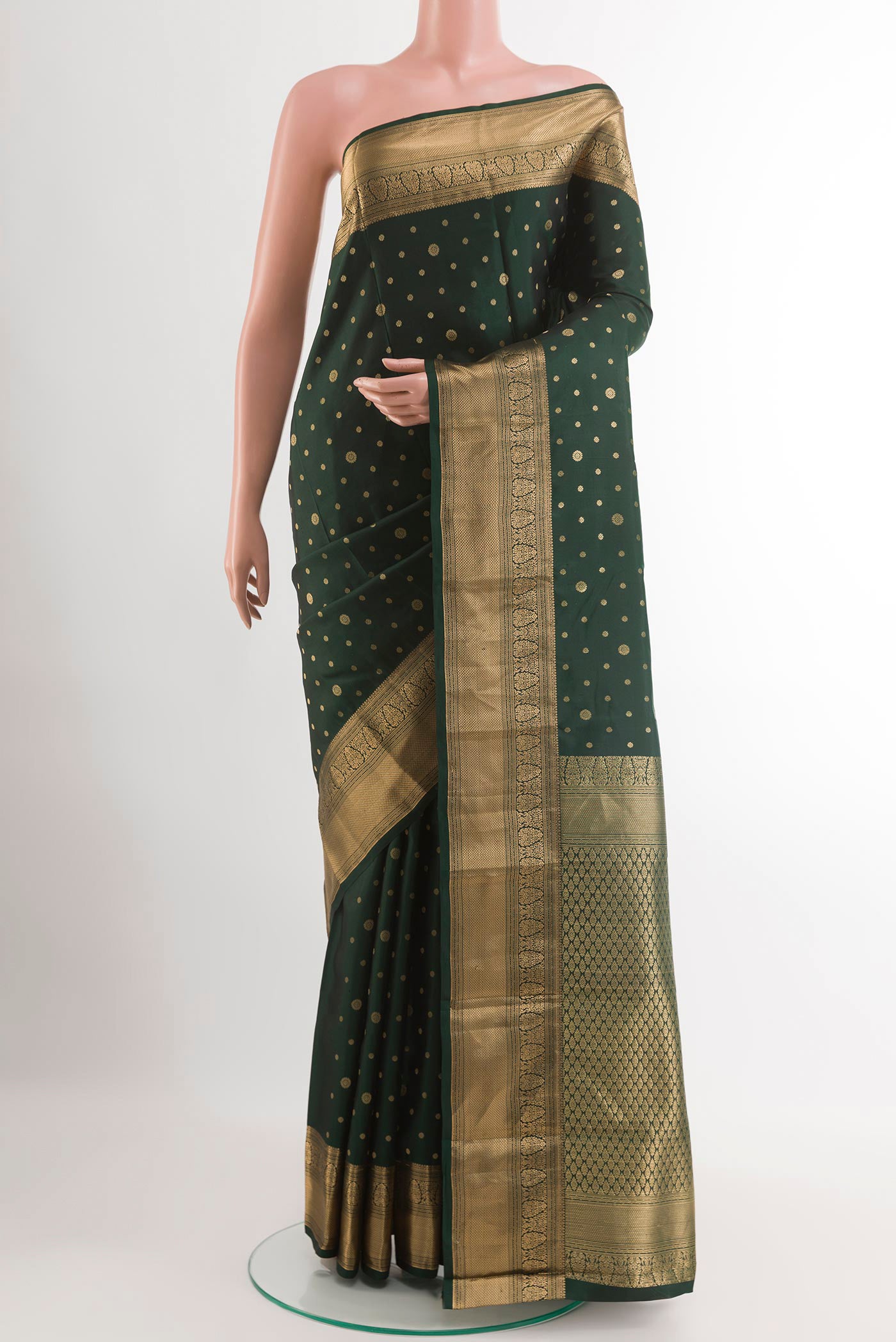 Bottle Green Kanjivaram Silk Saree with Zari Butta on the body and Zari Border.  displayed on a mannequin