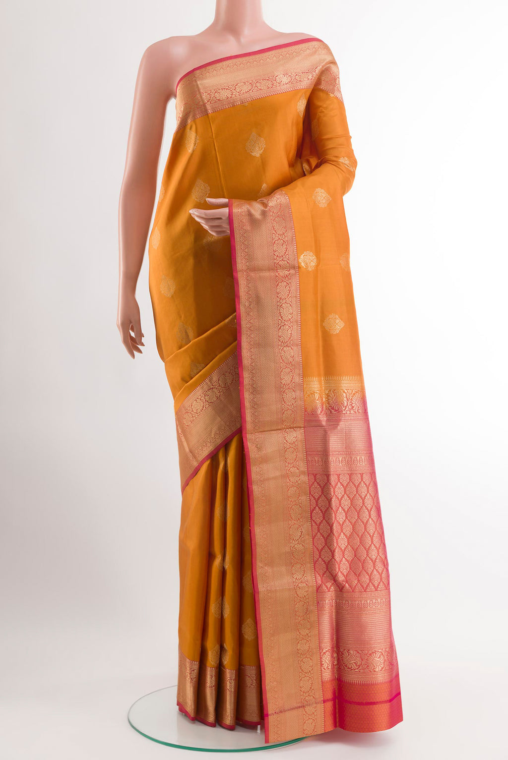 Yellow Soft Silk Saree with Zari Butta on the body and Zari Border.  displayed on a mannequin