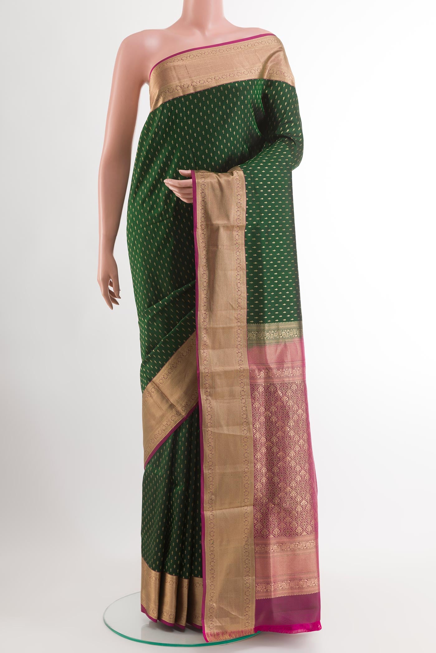 Green Soft Silk Saree with Zari Butta on the body and Zari Border.  displayed on a mannequin