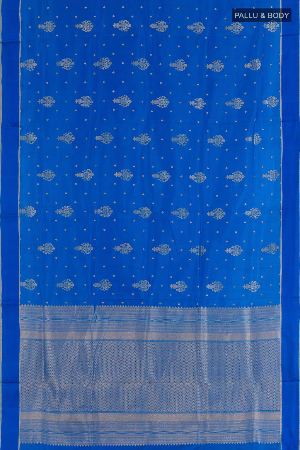 Flat view of Blue Soft Silk Saree with Zari Butta on the body and Zari Border. 