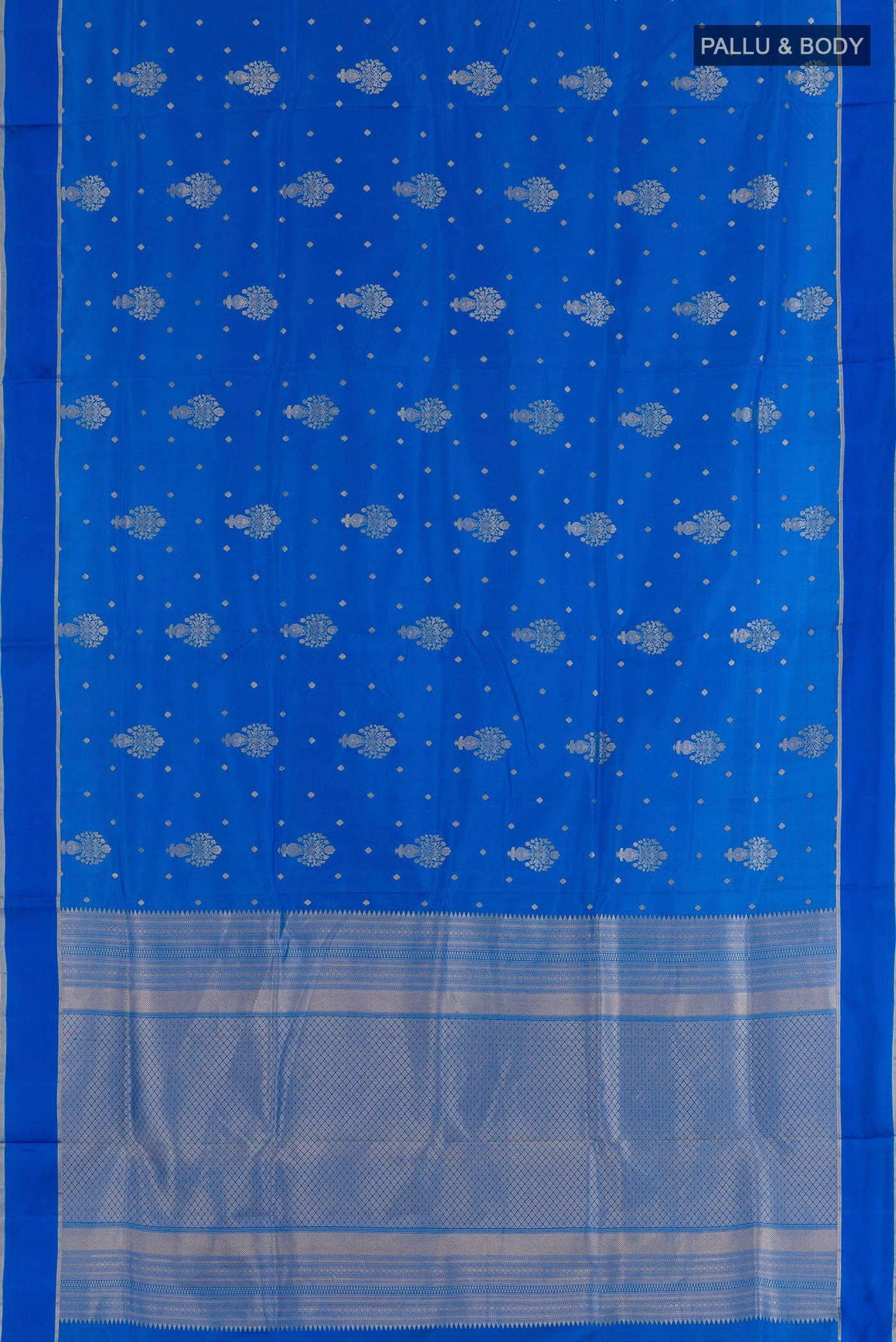 Flat view of Blue Soft Silk Saree with Zari Butta on the body and Zari Border. 