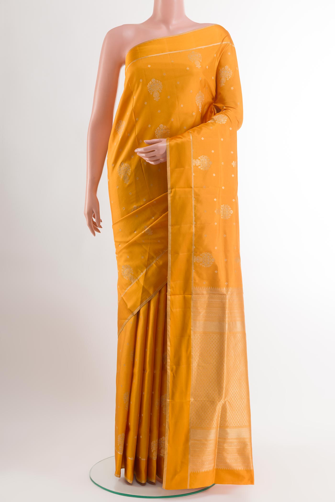 Yellow Soft Silk Saree with Zari Butta on the body and Zari Border.  displayed on a mannequin