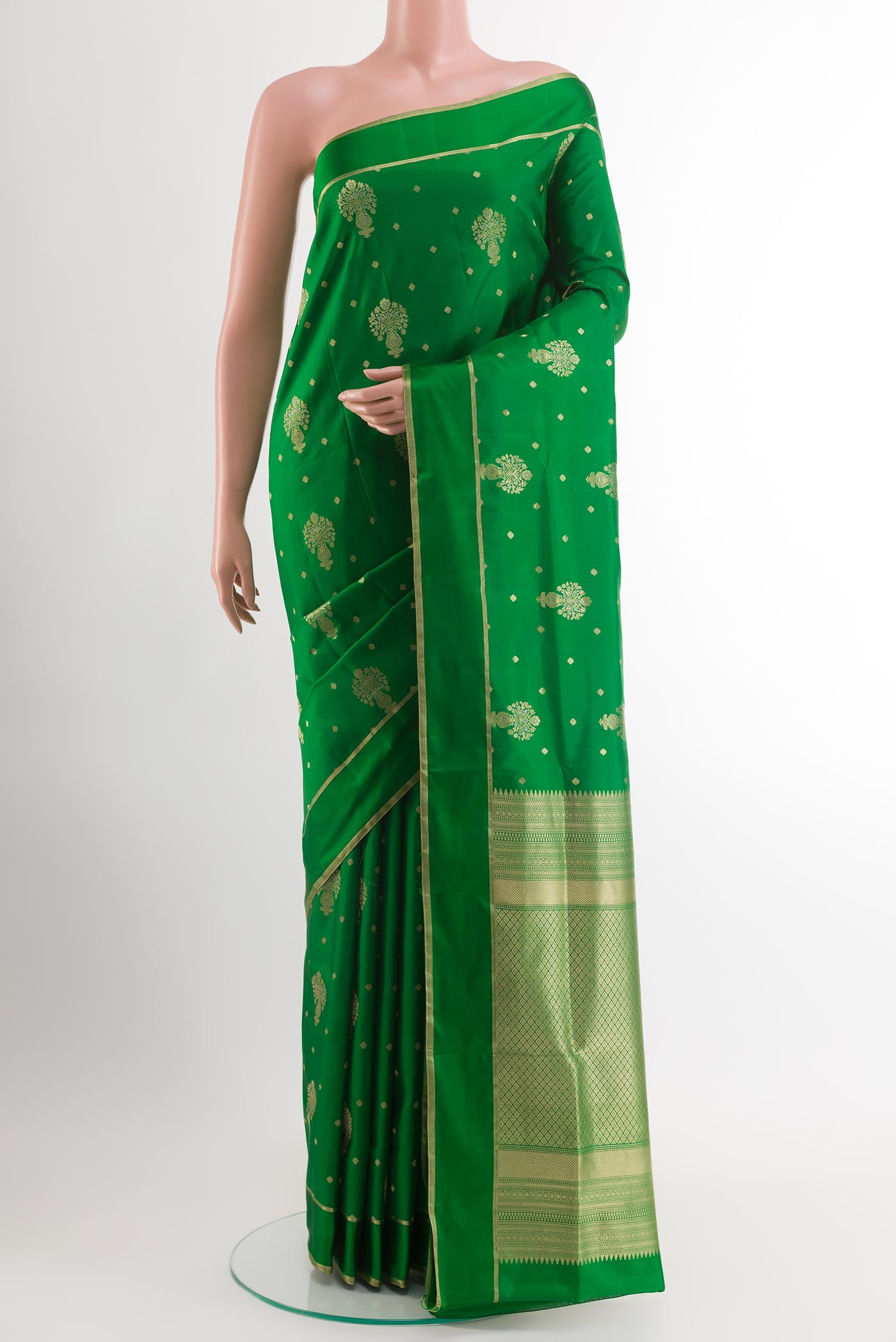 Green Soft Silk Saree with Zari Butta on the body and Zari Border.  displayed on a mannequin