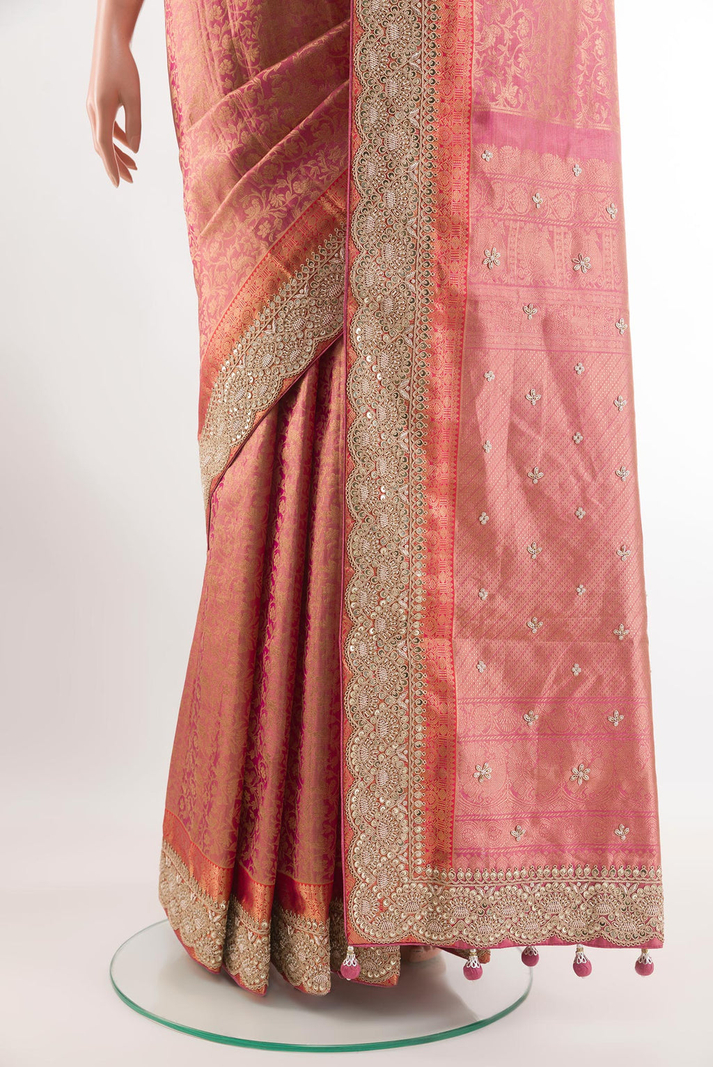 Pleats and pallu of Pink Tissue Silk Saree with Zari Brocade on the body and Embroidery Border. 