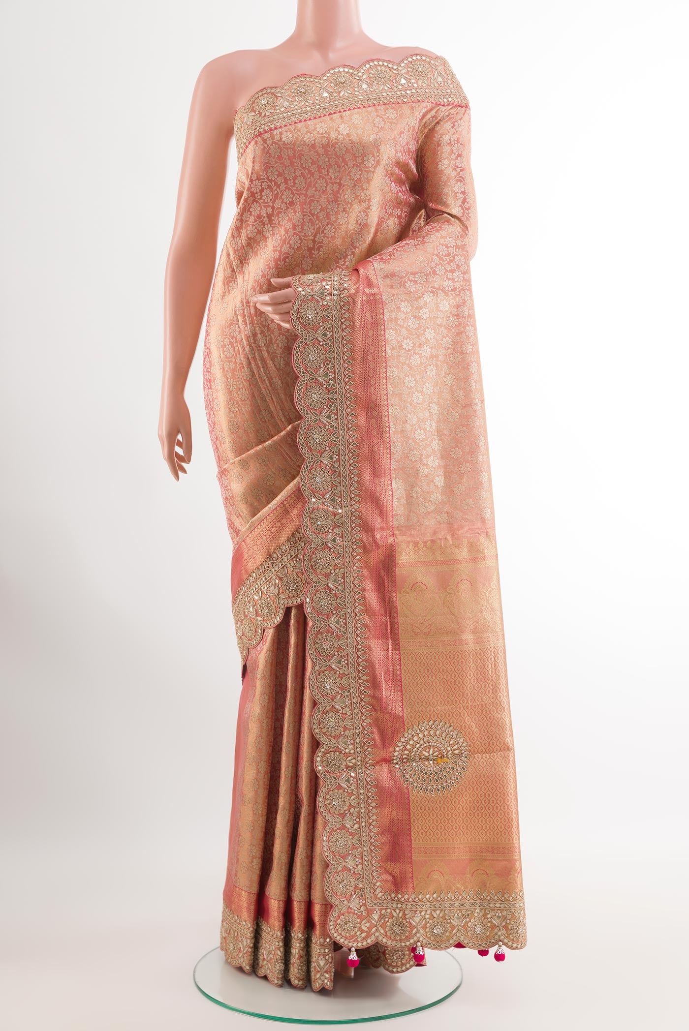 Rose Gold Tissue Silk Saree with Zari Brocade on the body and Embroidery Border.  displayed on a mannequin