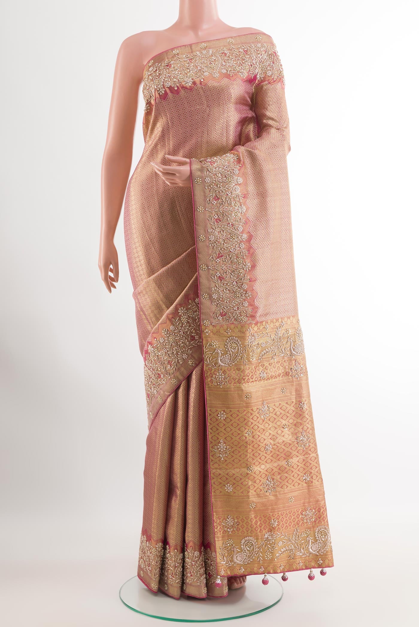 Rose Gold Tissue Silk Saree with Zari Brocade on the body and Embroidery Border.  displayed on a mannequin
