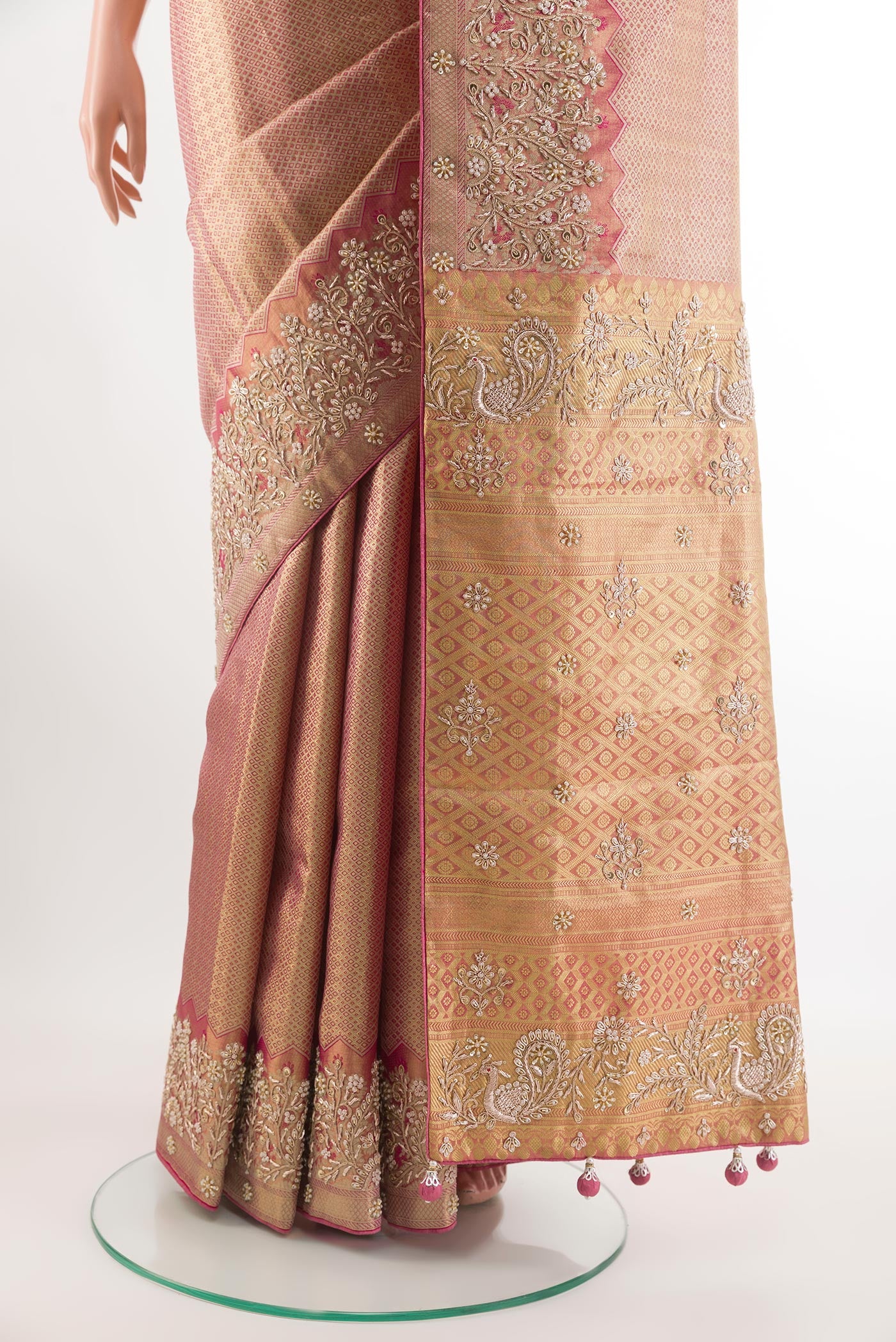 Pleats and pallu of Rose Gold Tissue Silk Saree with Zari Brocade on the body and Embroidery Border. 
