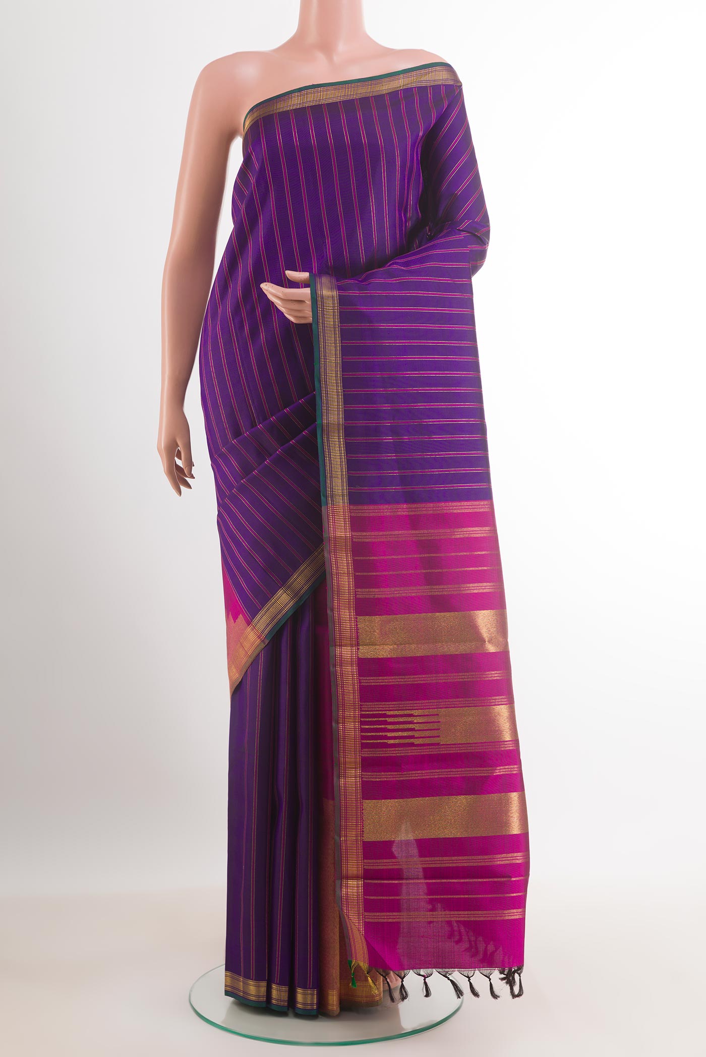 Purple Kanchipuram Silk Saree with Stripes on the body and Zari Border.  displayed on a mannequin