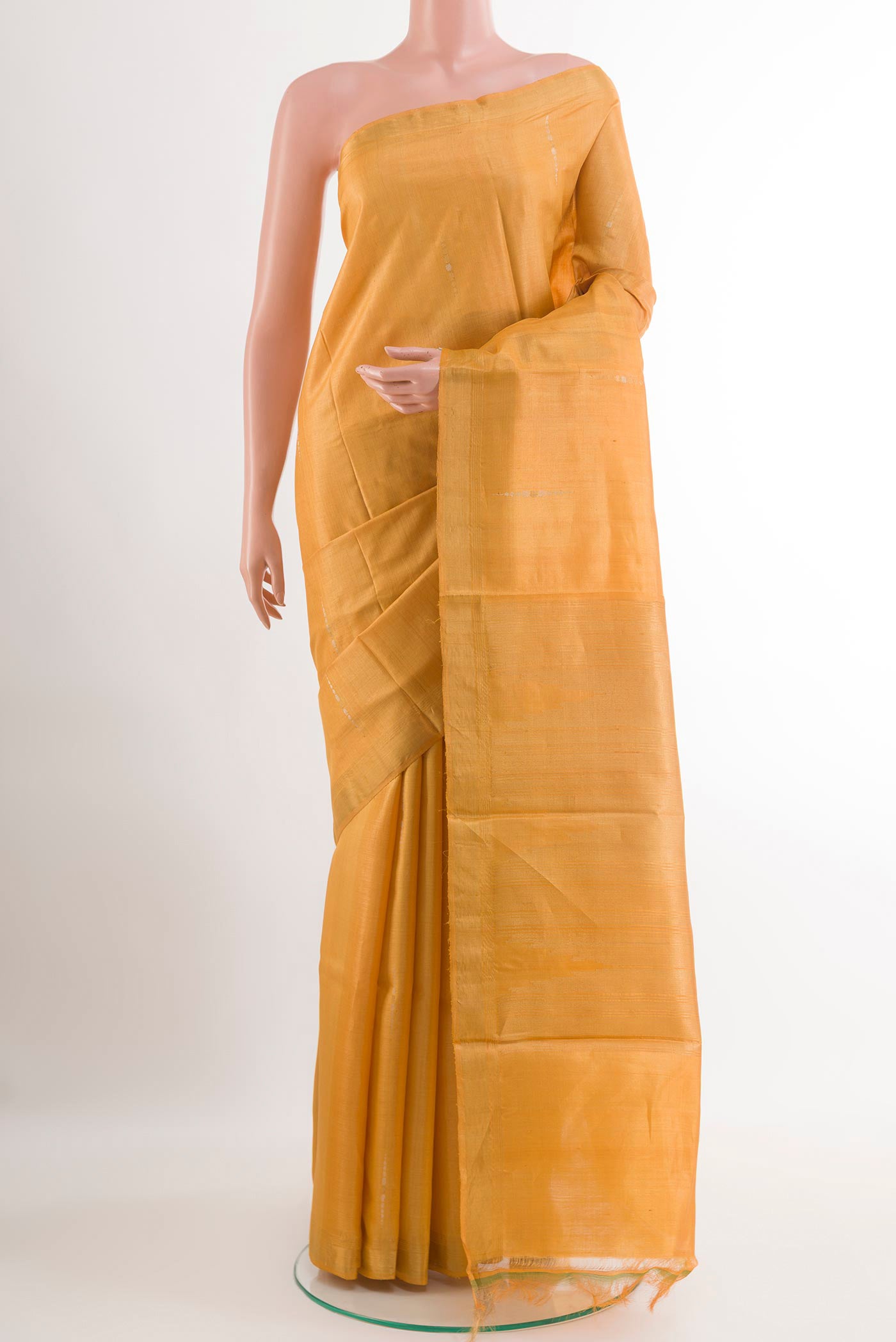 Yellow Tussar Silk Saree with Zari Butta on the body and Zari Border.  displayed on a mannequin