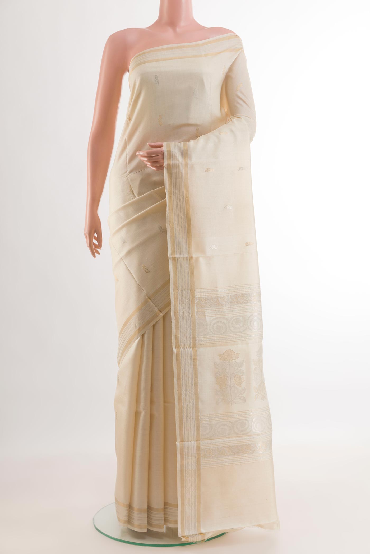 Off White Tussar Silk Saree with Zari Butta on the body and Zari Border.  displayed on a mannequin