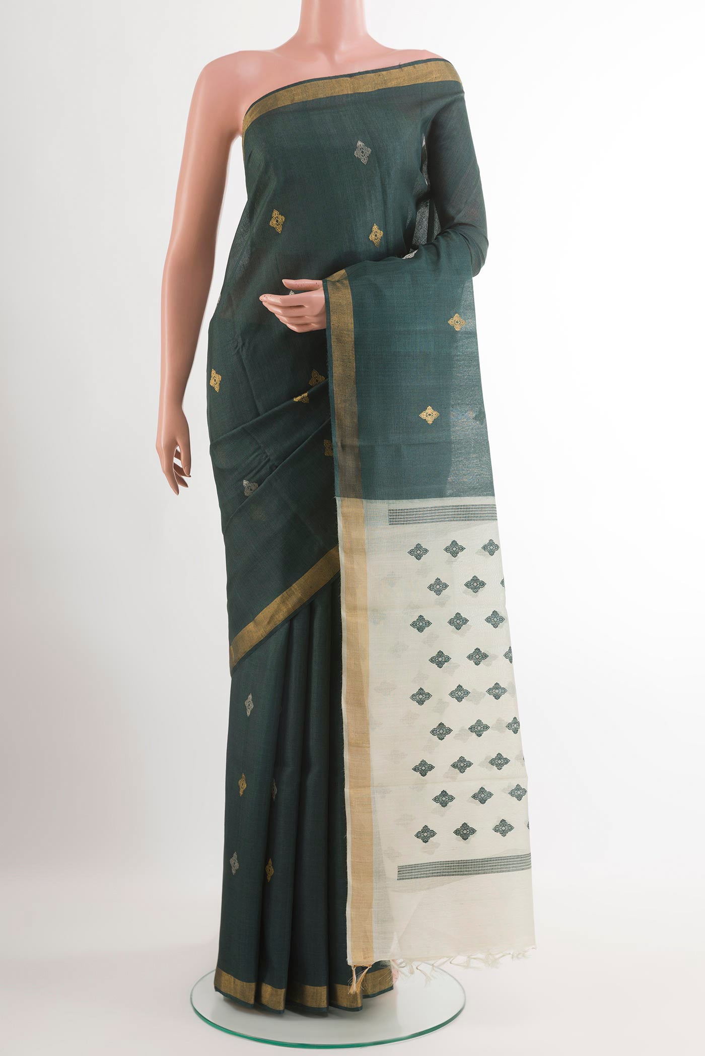 Bottle Green Tussar Silk Saree with Zari Butta on the body and Zari Border.  displayed on a mannequin