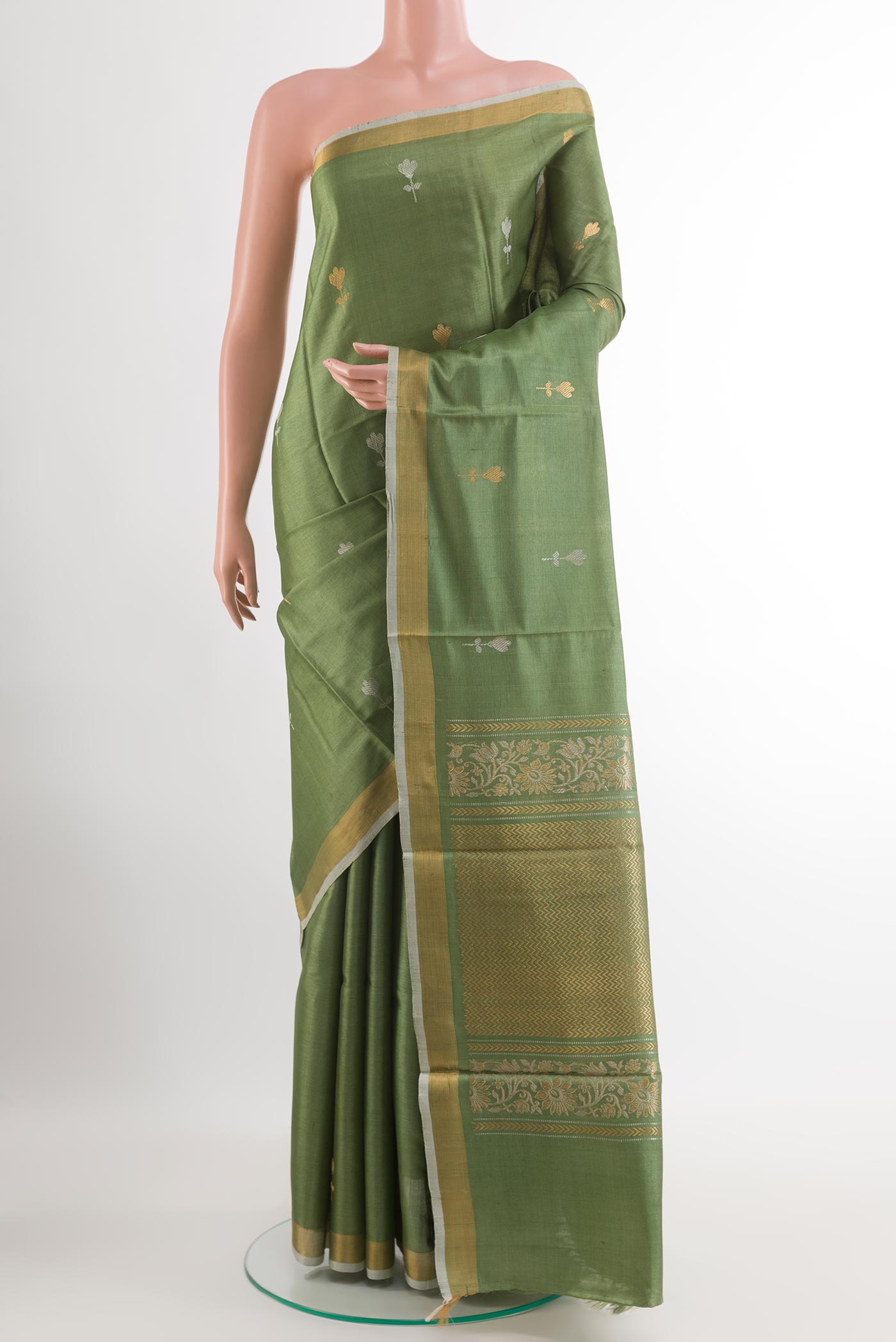 Green Tussar Silk Saree with Zari Butta on the body and Zari Border.  displayed on a mannequin