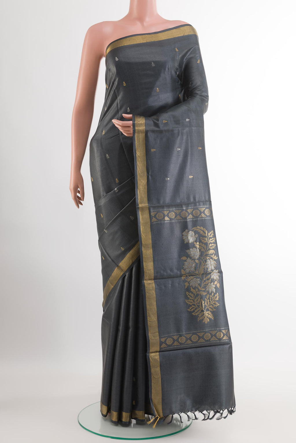 Grey Tussar Silk Saree with Zari Butta on the body and Zari Border.  displayed on a mannequin